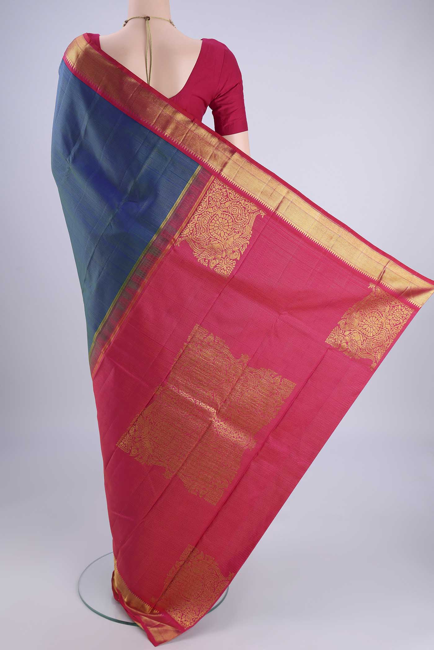 Flat view of Peacock Blue Kanchipuram Silk Saree with Stripes on the body and Zari Border. 