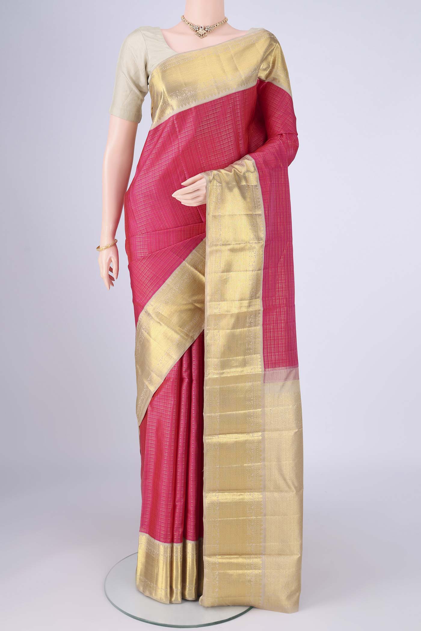 Rani Pink Kanchipuram Silk Saree with Checked design on the body and Zari Border.  displayed on a mannequin