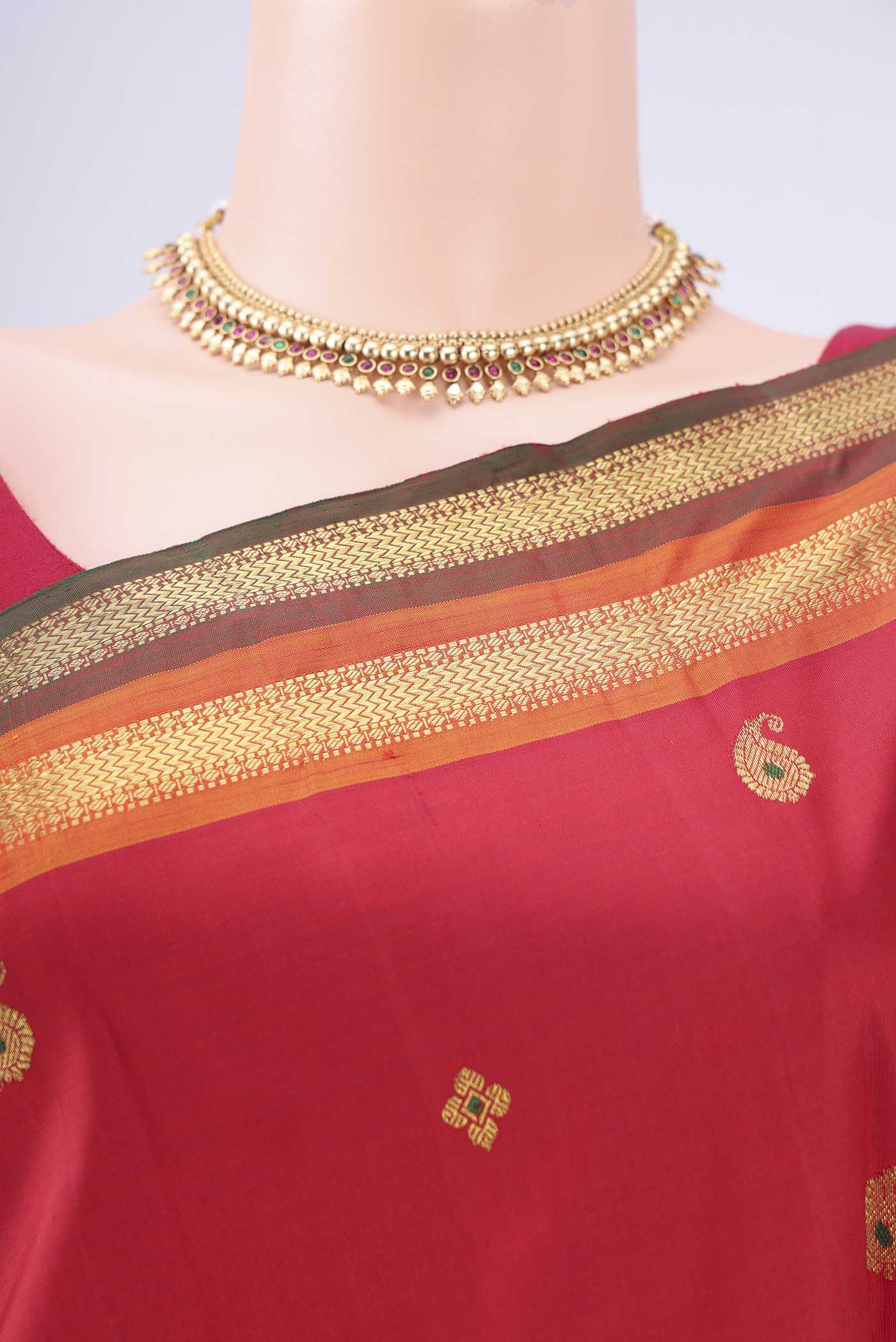 Border image of Red Kanjivaram Silk Saree with Zari Butta on the body and Zari Border. 