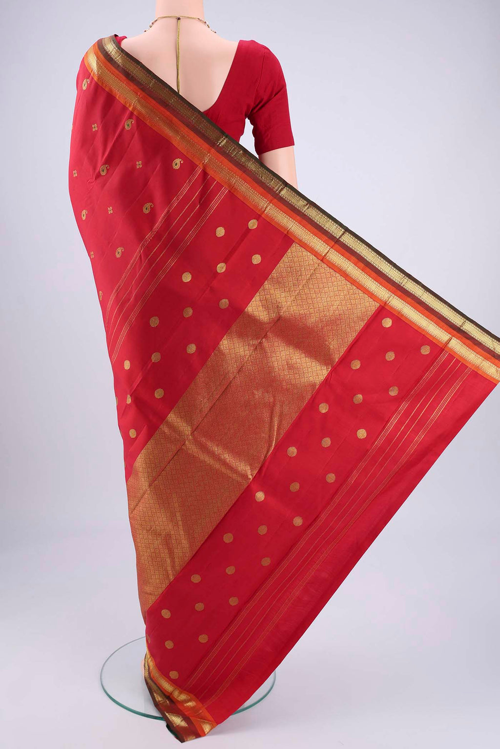 Flat view of Red Kanjivaram Silk Saree with Zari Butta on the body and Zari Border. 