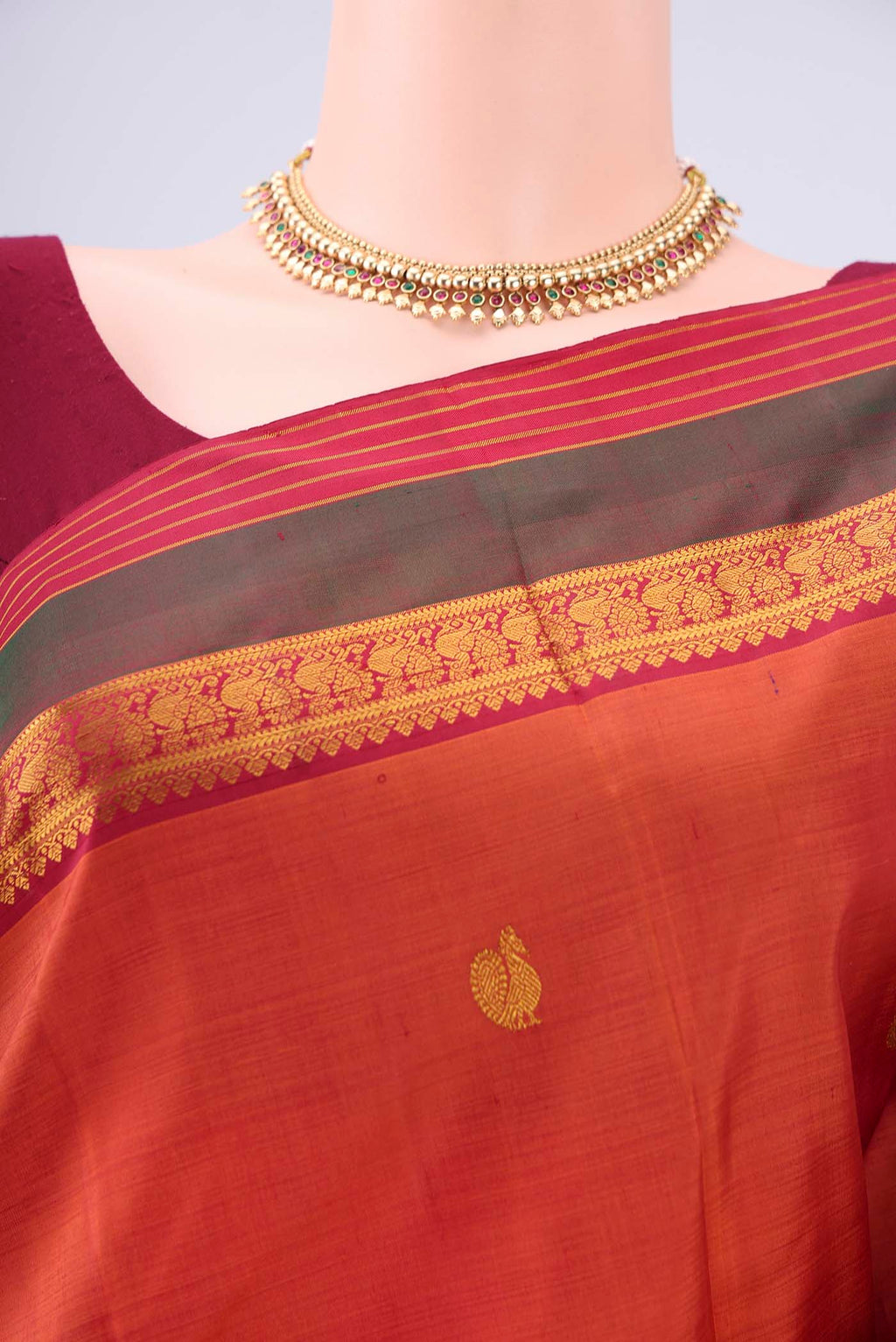 Border image of Rust Kanjivaram Silk Saree with Zari Butta on the body and Zari Border. 