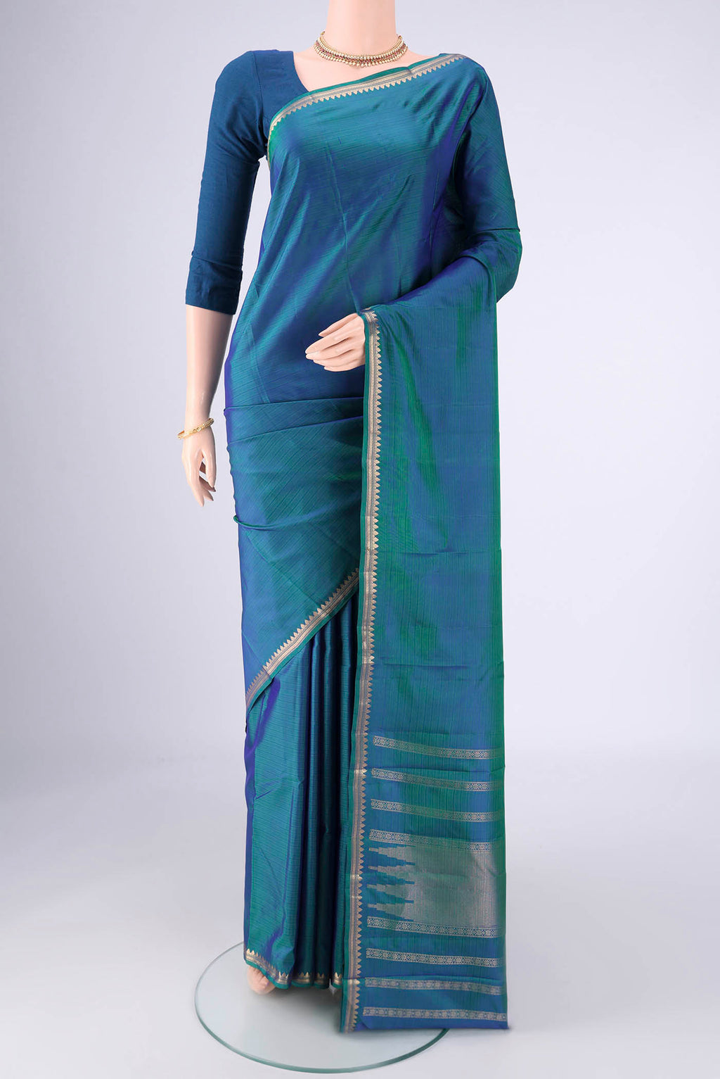 Blue Dual Tone Kanjivaram Silk Saree with Plain Body and Zari Border.  displayed on a mannequin