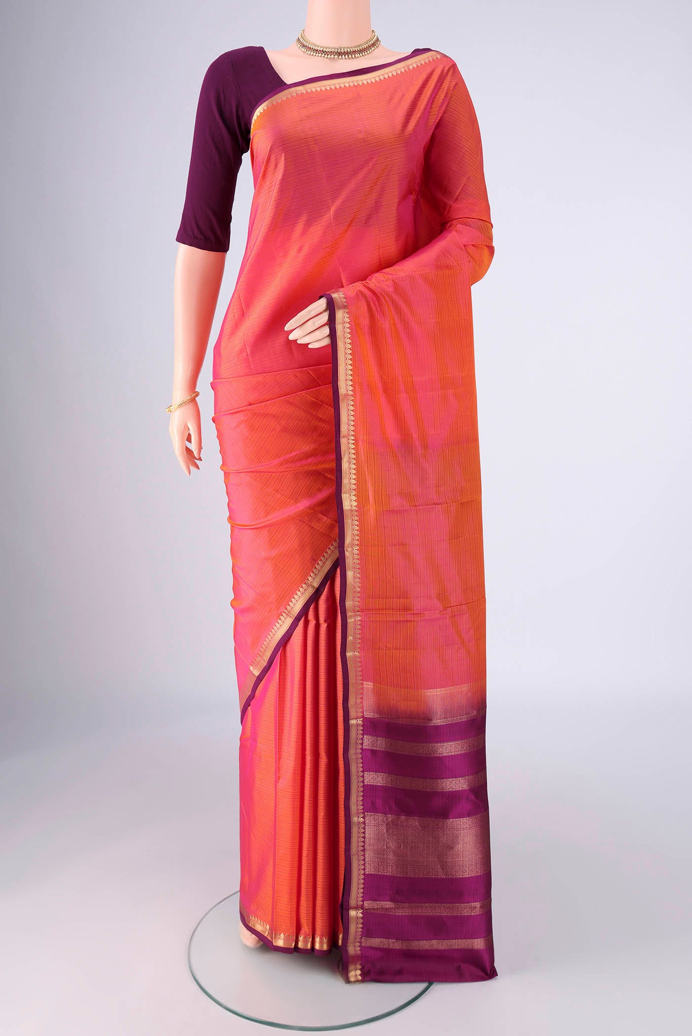 Coral Dual Tone Kanjivaram Silk Saree with Stripes on the body and Zari Border.  displayed on a mannequin