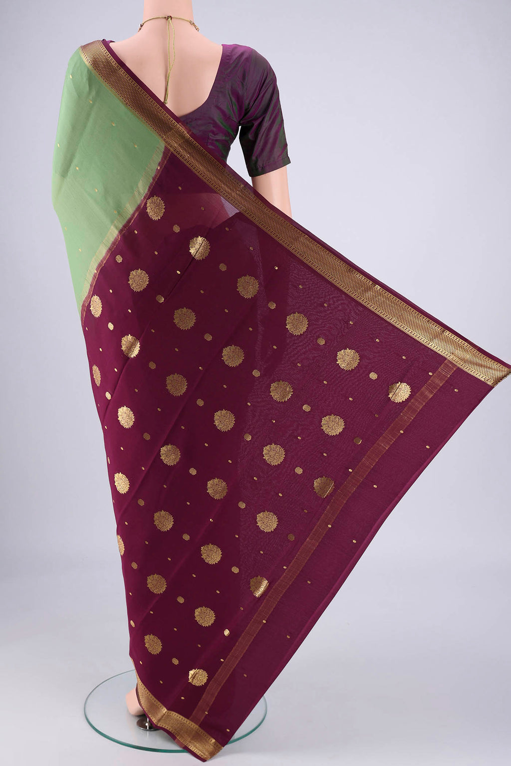 Flat view of Pista Green Mysore Georgette Saree with Zari Butta on the body and Zari Border. 