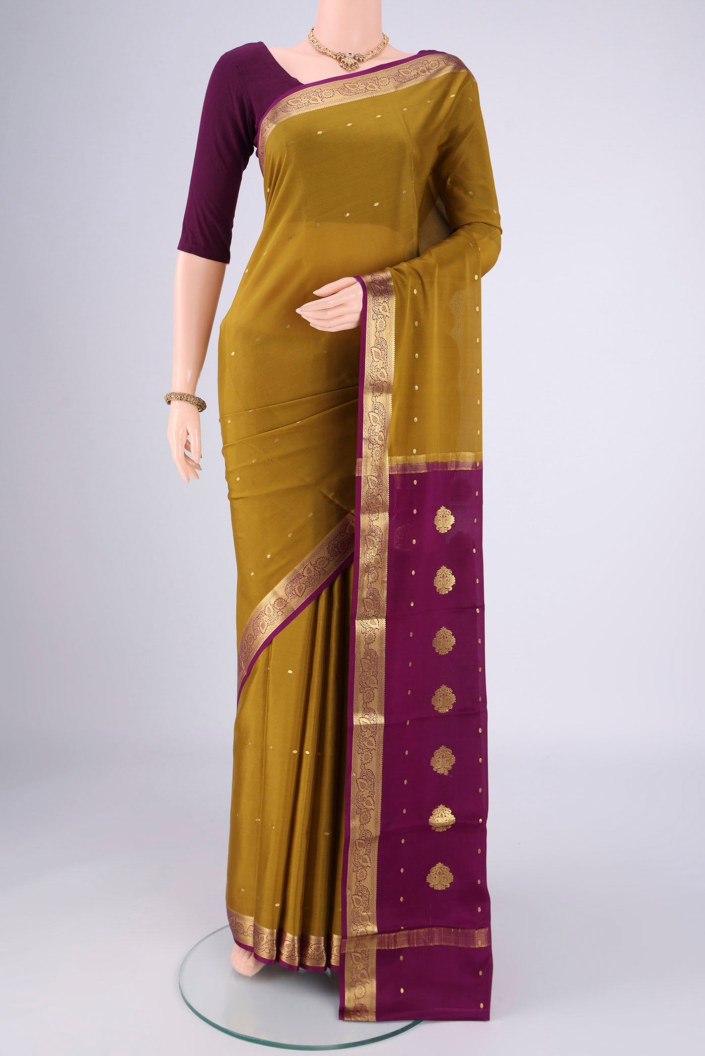 Mehandi Green Mysore Georgette Saree with Zari Butta on the body and Zari Border.  displayed on a mannequin