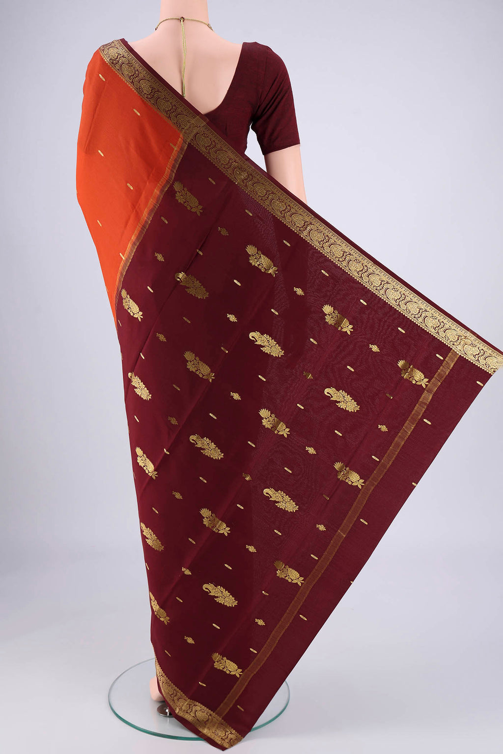 Flat view of Rust Mysore Georgette Saree with Zari Butta on the body and Zari Border. 