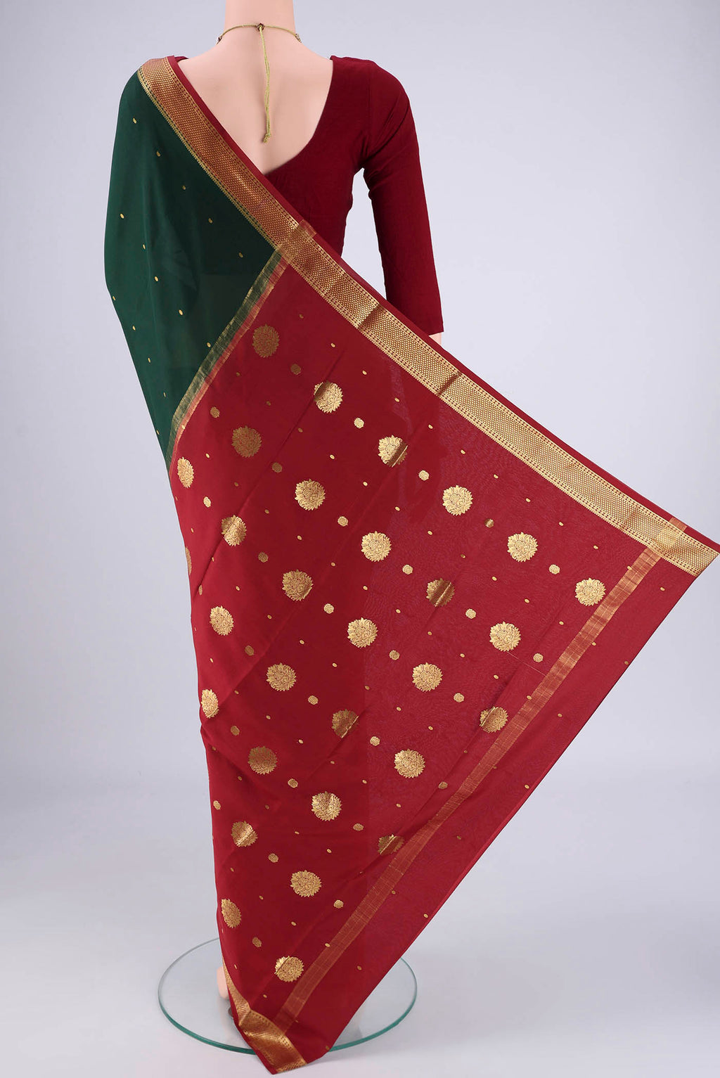 Flat view of Bottle Green Mysore Georgette Saree with Zari Butta on the body and Zari Border. 