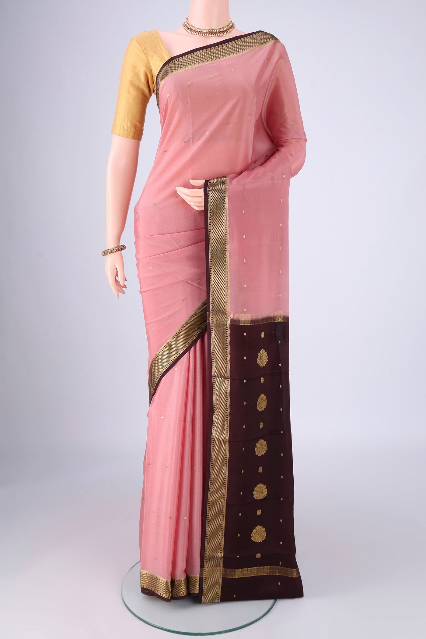 Rose pink Mysore Crepe Saree with Zari Butta on the body and Zari Border.  displayed on a mannequin