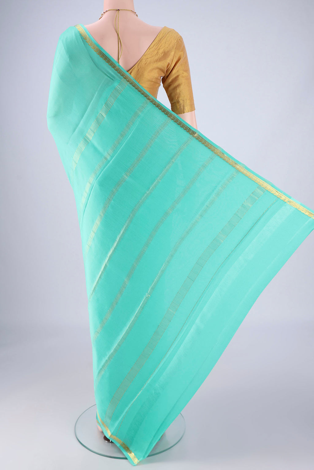 Flat view of Turquoise Mysore Crepe Saree with Plain Body and Zari Border. 