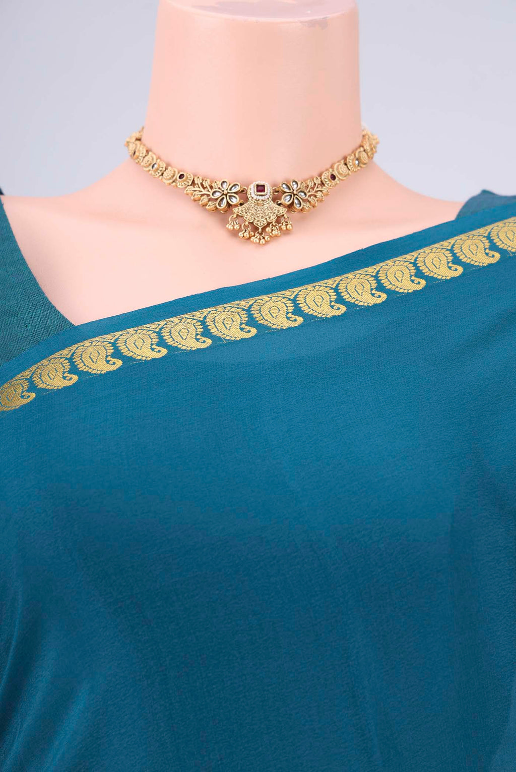 Teal Mysore Crepe Saree with Plain Body and Zari Border.  displayed on a mannequin