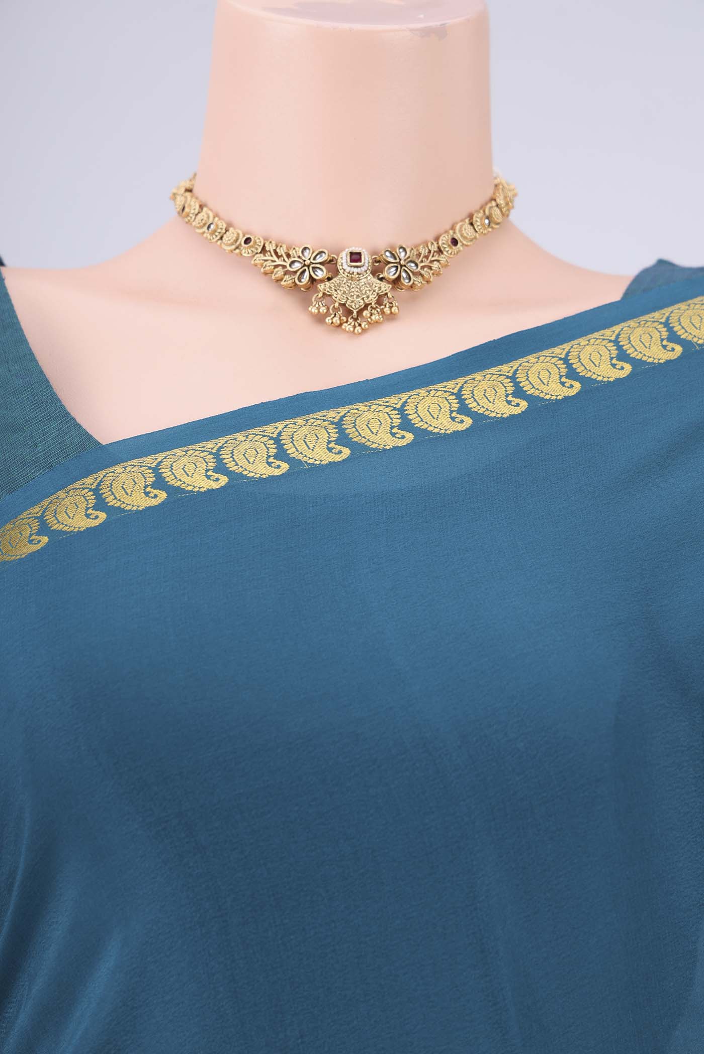 Teal Mysore Crepe Saree with Plain Body and Zari Border.  displayed on a mannequin