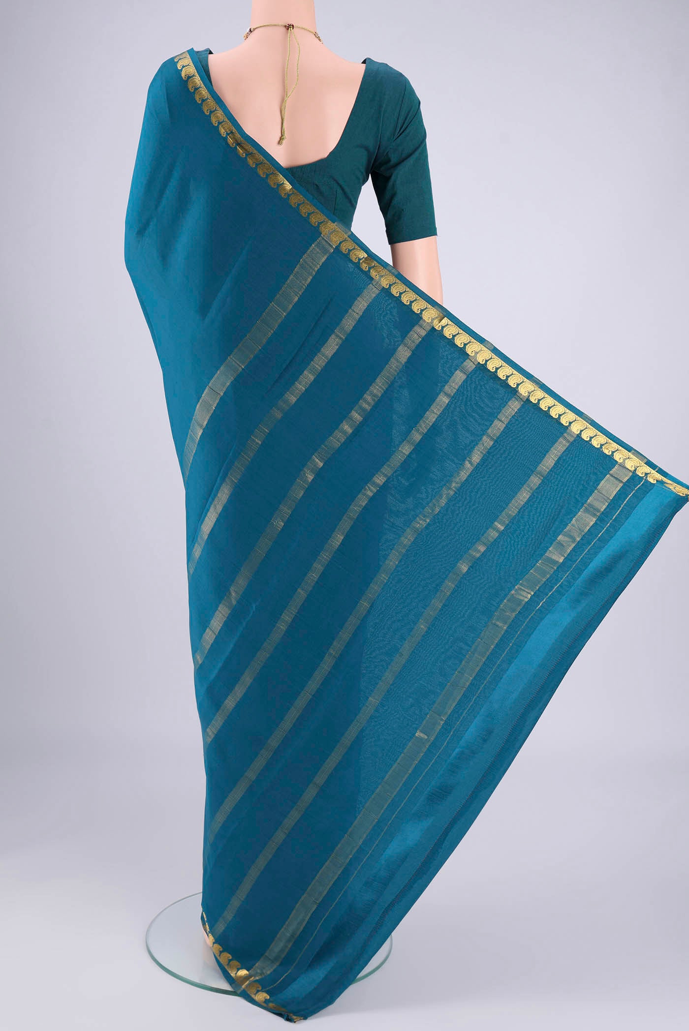 Flat view of Teal Mysore Crepe Saree with Plain Body and Zari Border. 