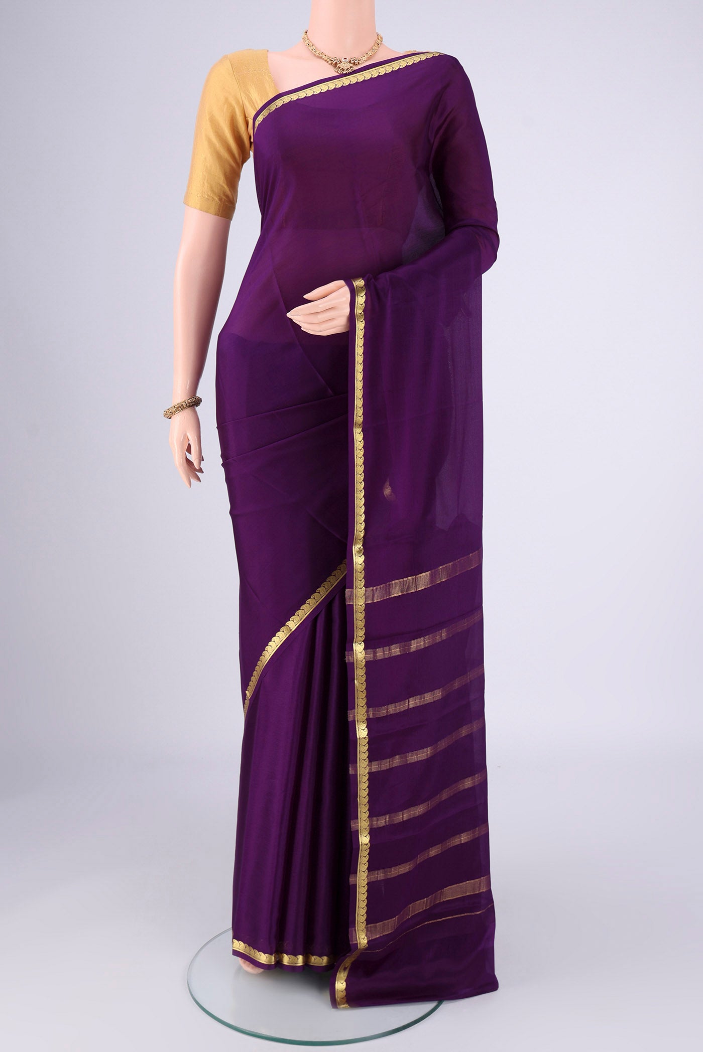 Purple Mysore Crepe Saree with Plain Body and Zari Border.  displayed on a mannequin