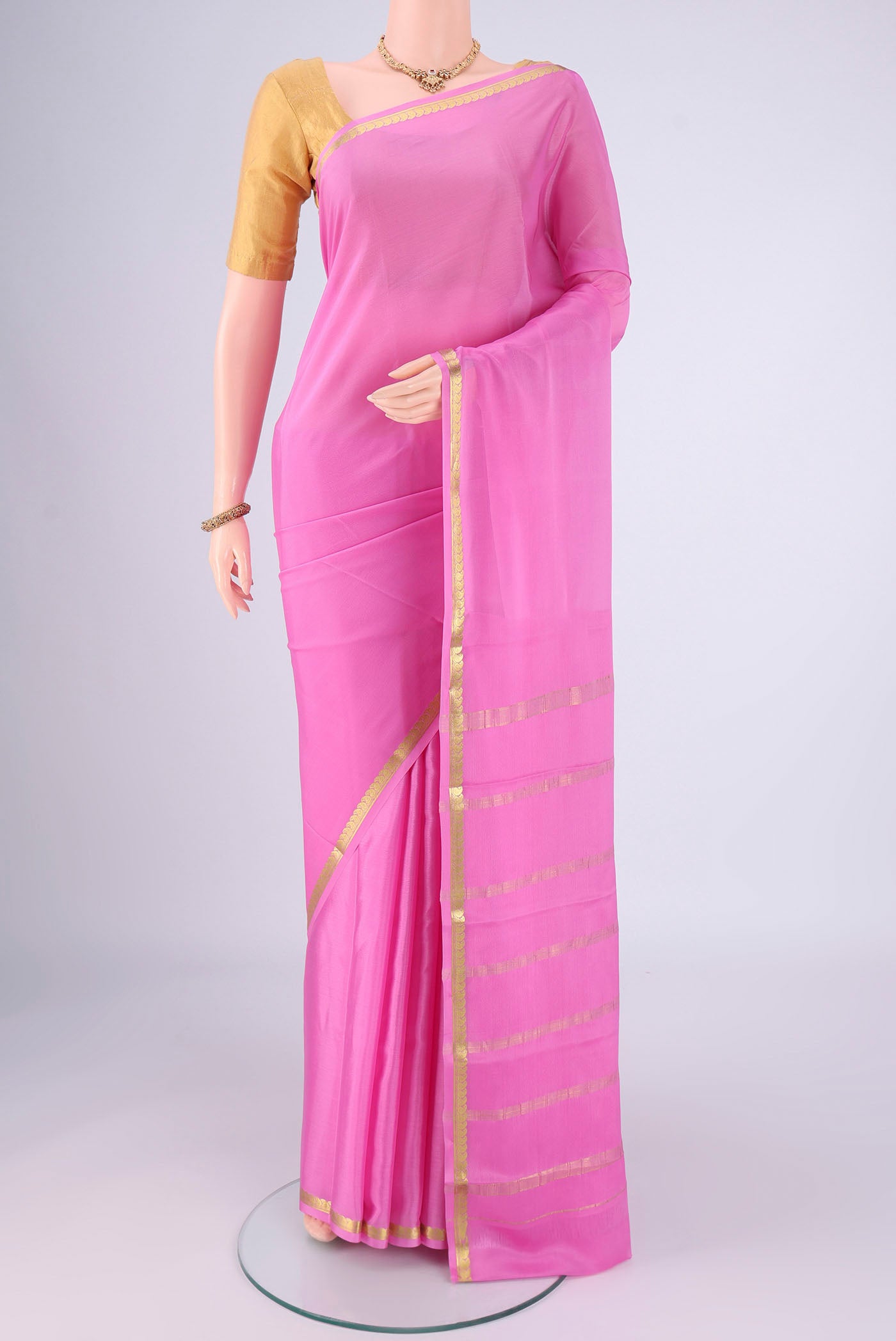 Rose pink Mysore Crepe Saree with Plain Body and Zari Border.  displayed on a mannequin