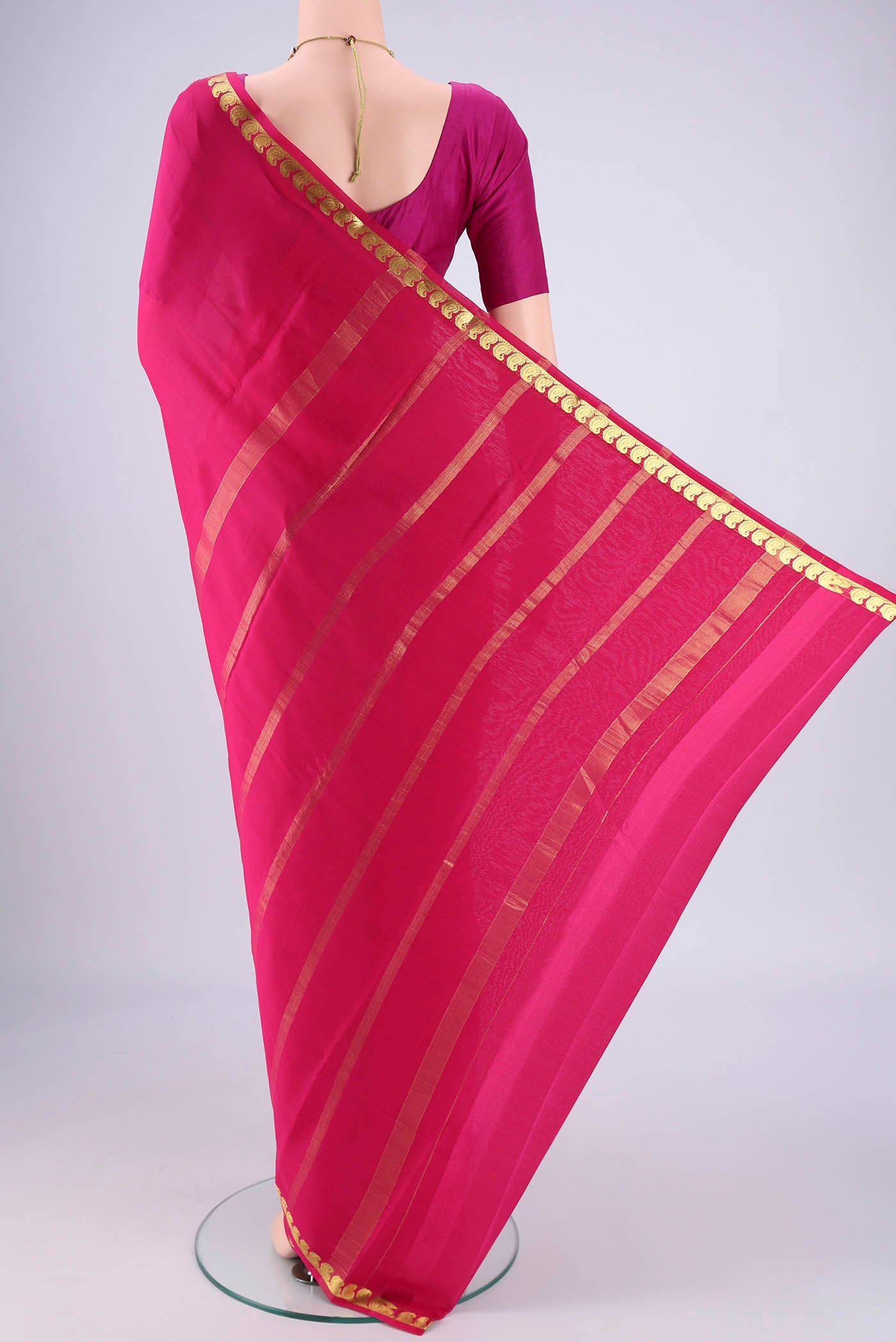 Flat view of Rani Pink Mysore Crepe Saree with Plain Body and Zari Border. 