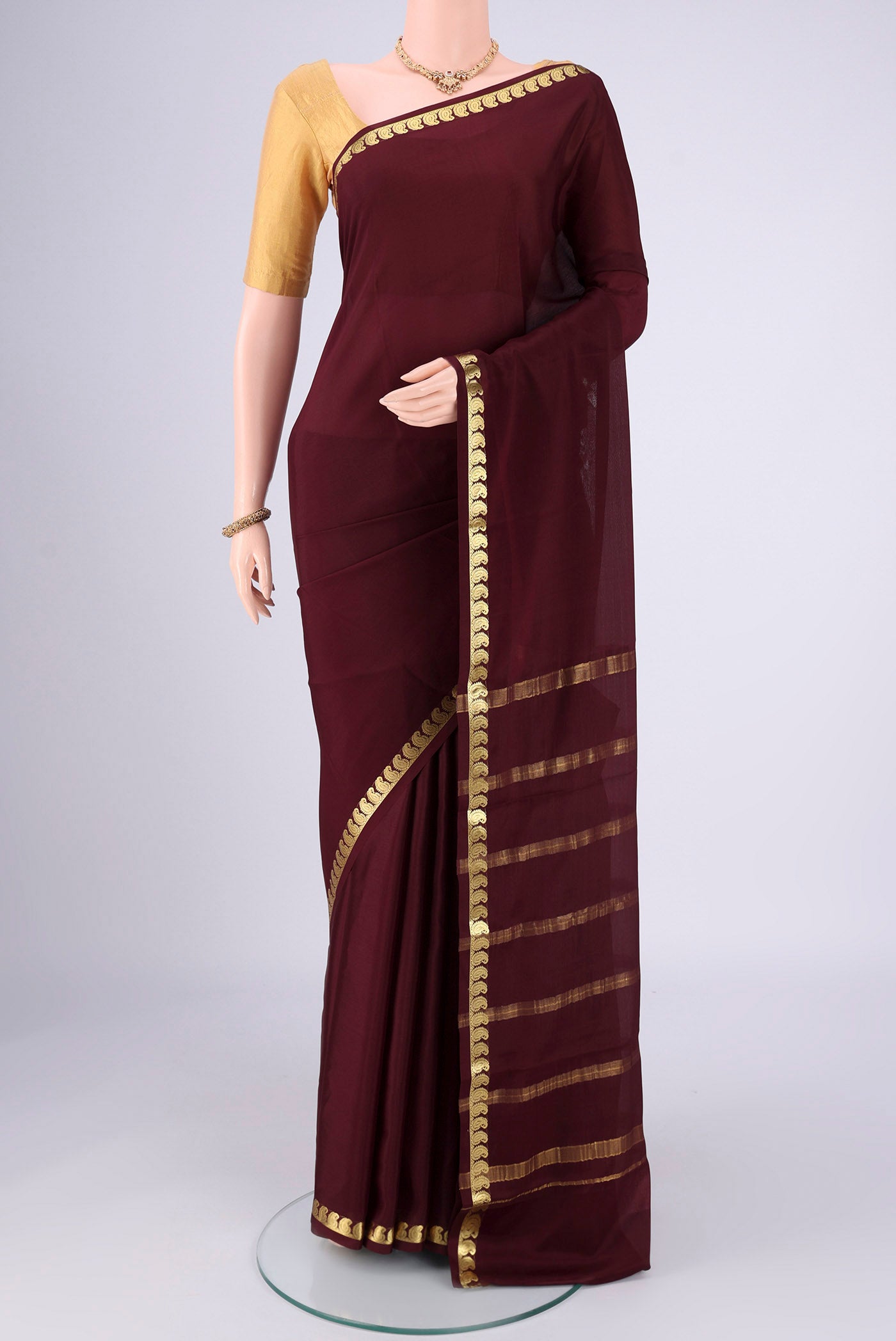 Coffee Brown Mysore Crepe Saree with Plain Body and Zari Border.  displayed on a mannequin