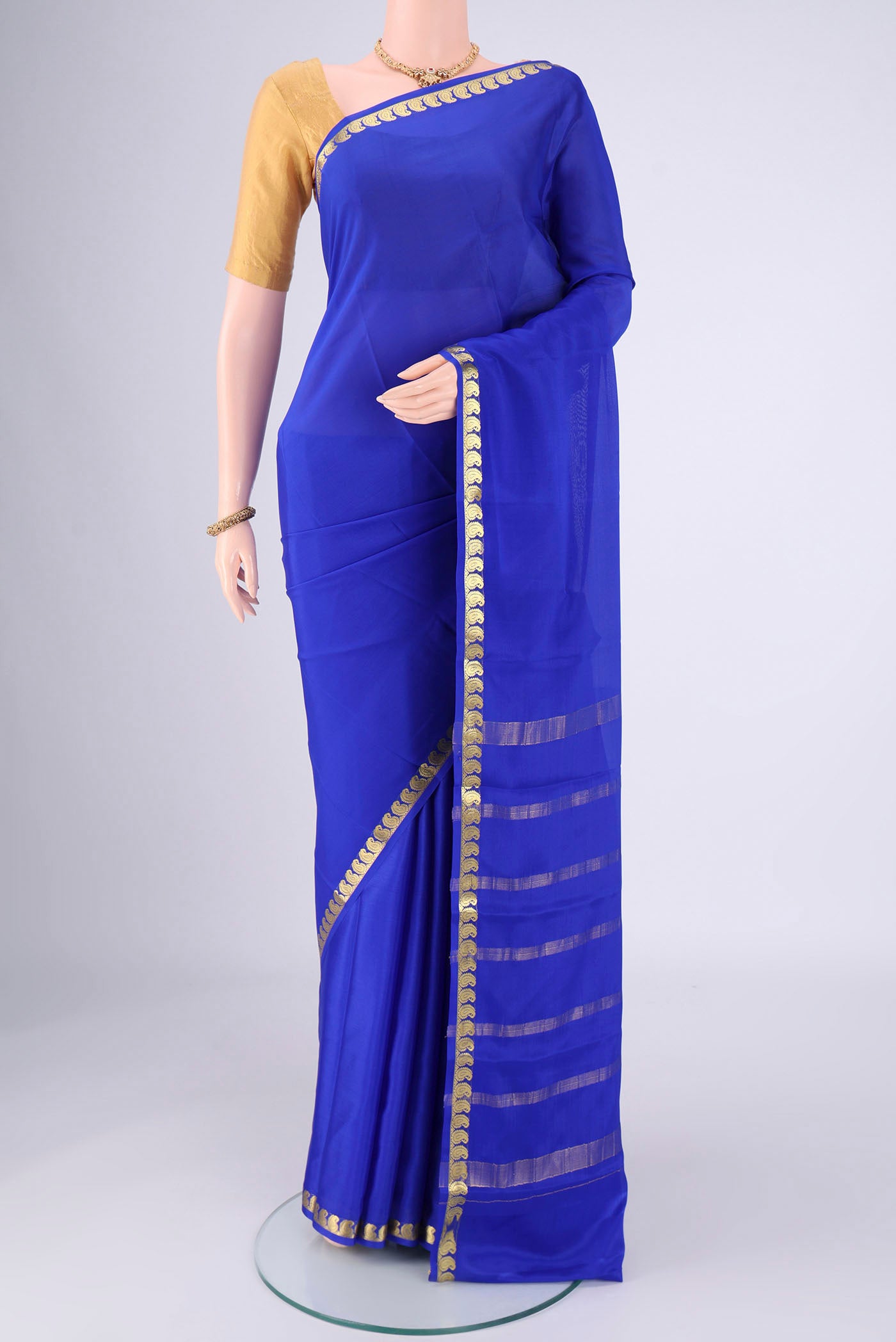 Royal Blue Mysore Crepe Saree with Plain Body and Zari Border.  displayed on a mannequin