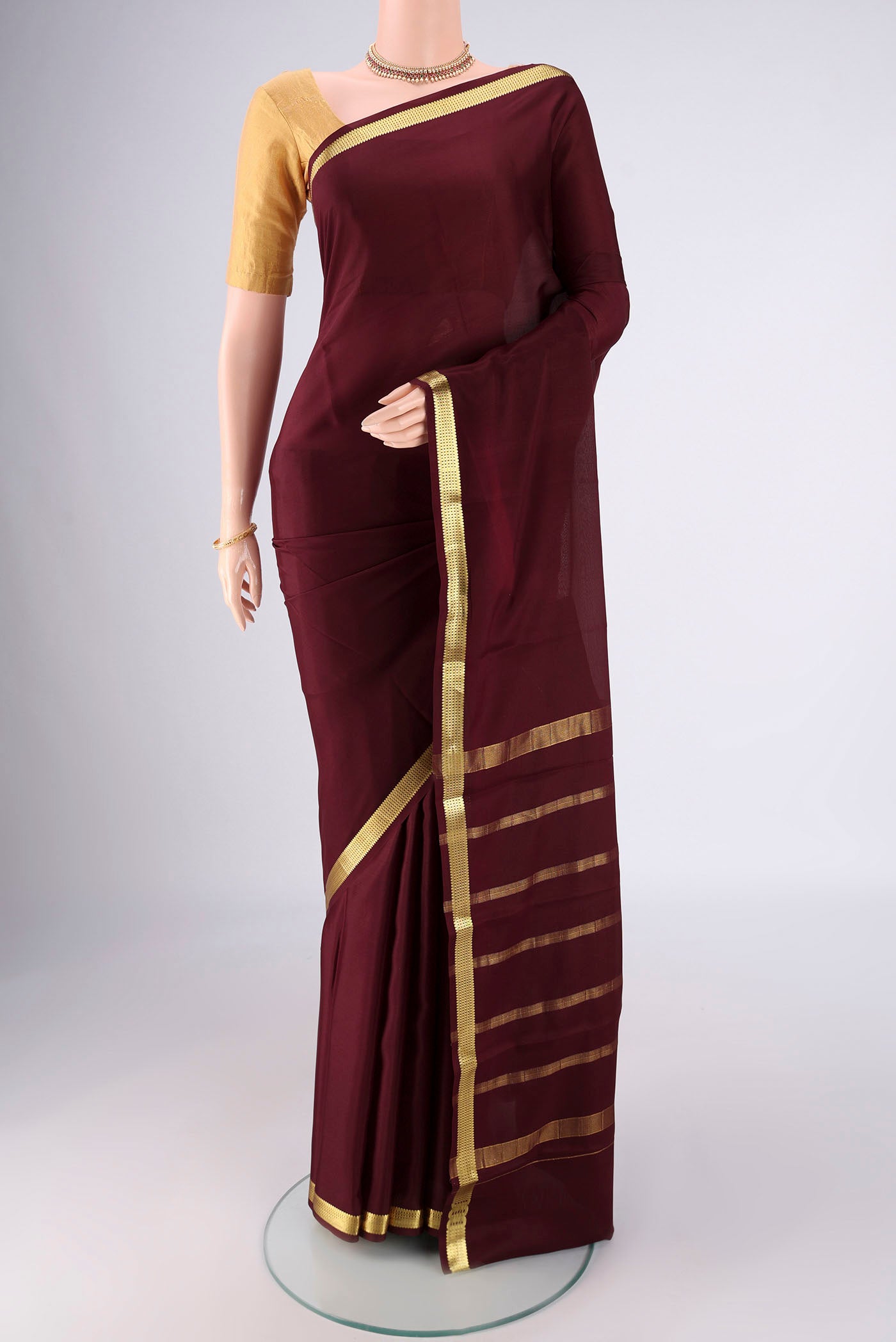 Coffee Brown Mysore Crepe Saree with Plain Body and Zari Border.  displayed on a mannequin