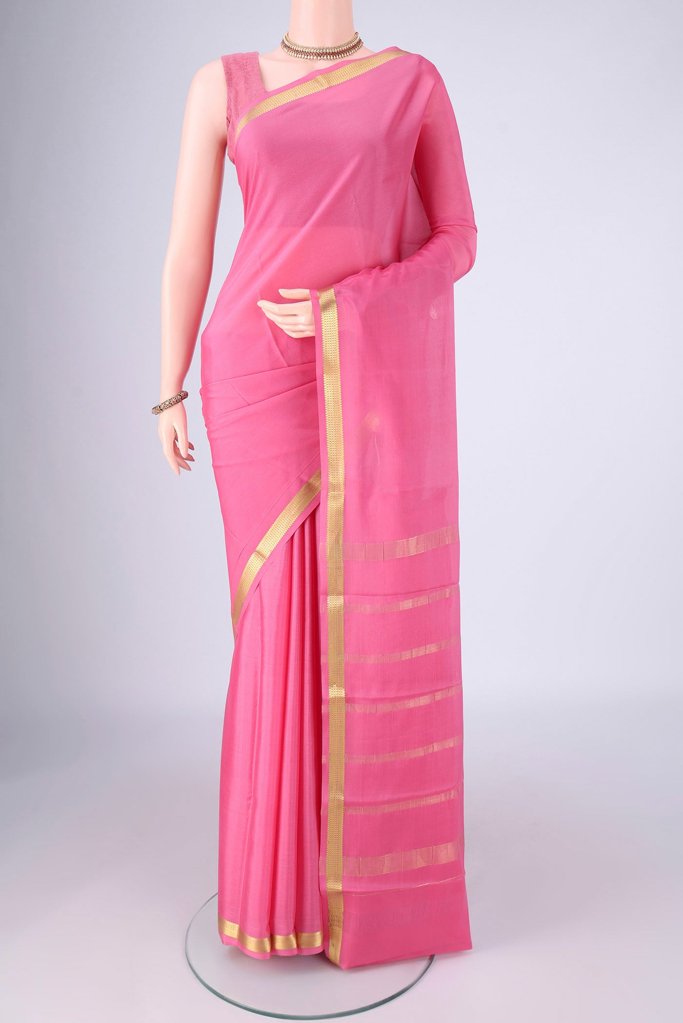 Pink Mysore Crepe Saree with Plain Body and Zari Border.  displayed on a mannequin