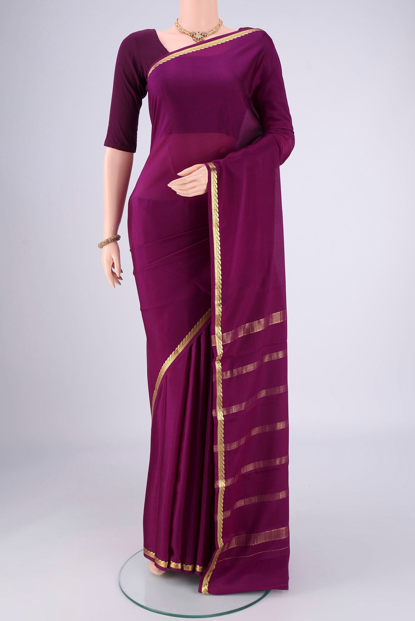 Purple Mysore Crepe Saree with Plain Body and Zari Border.  displayed on a mannequin