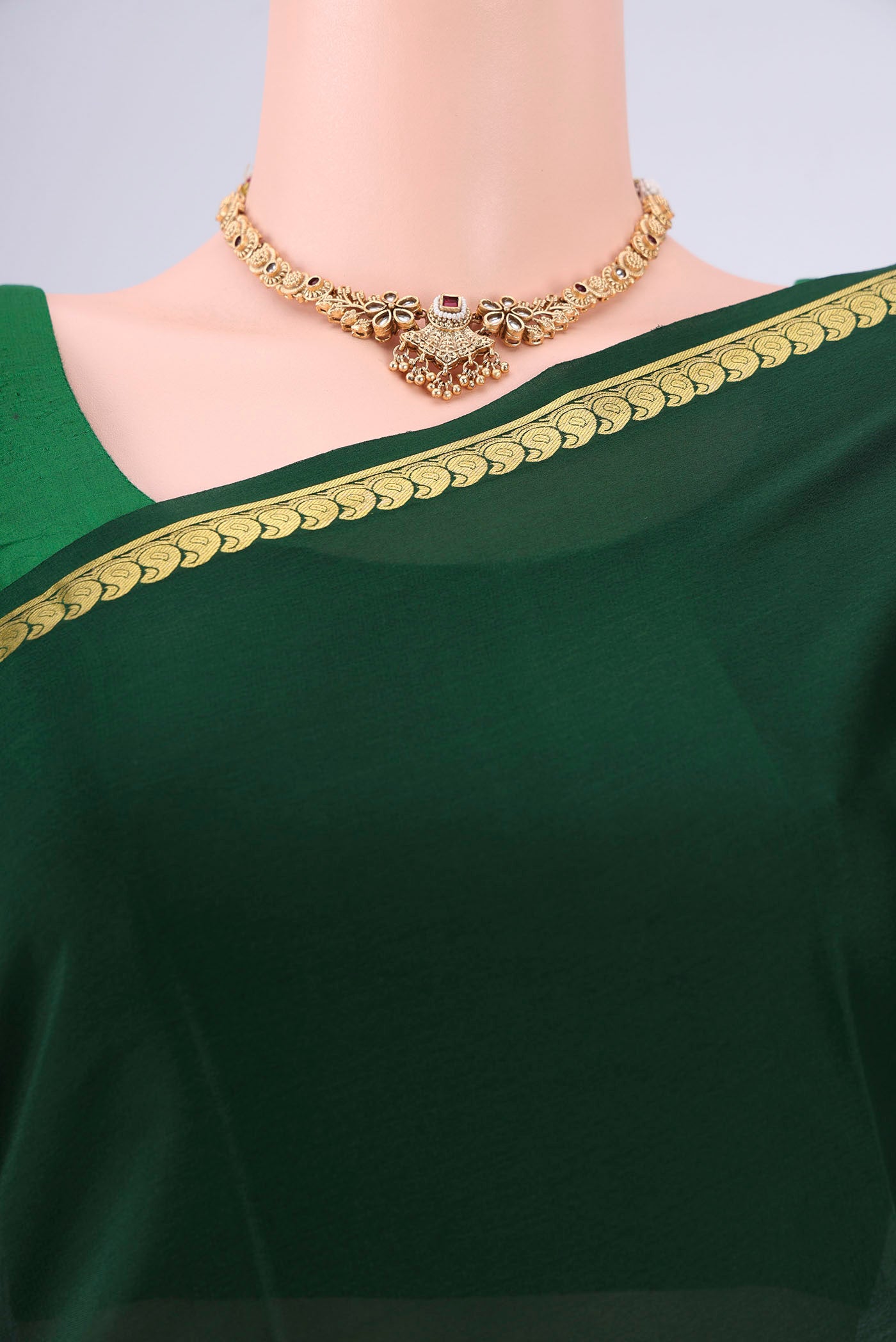 Bottle Green Mysore Crepe Saree with Plain Body and Zari Border.  displayed on a mannequin