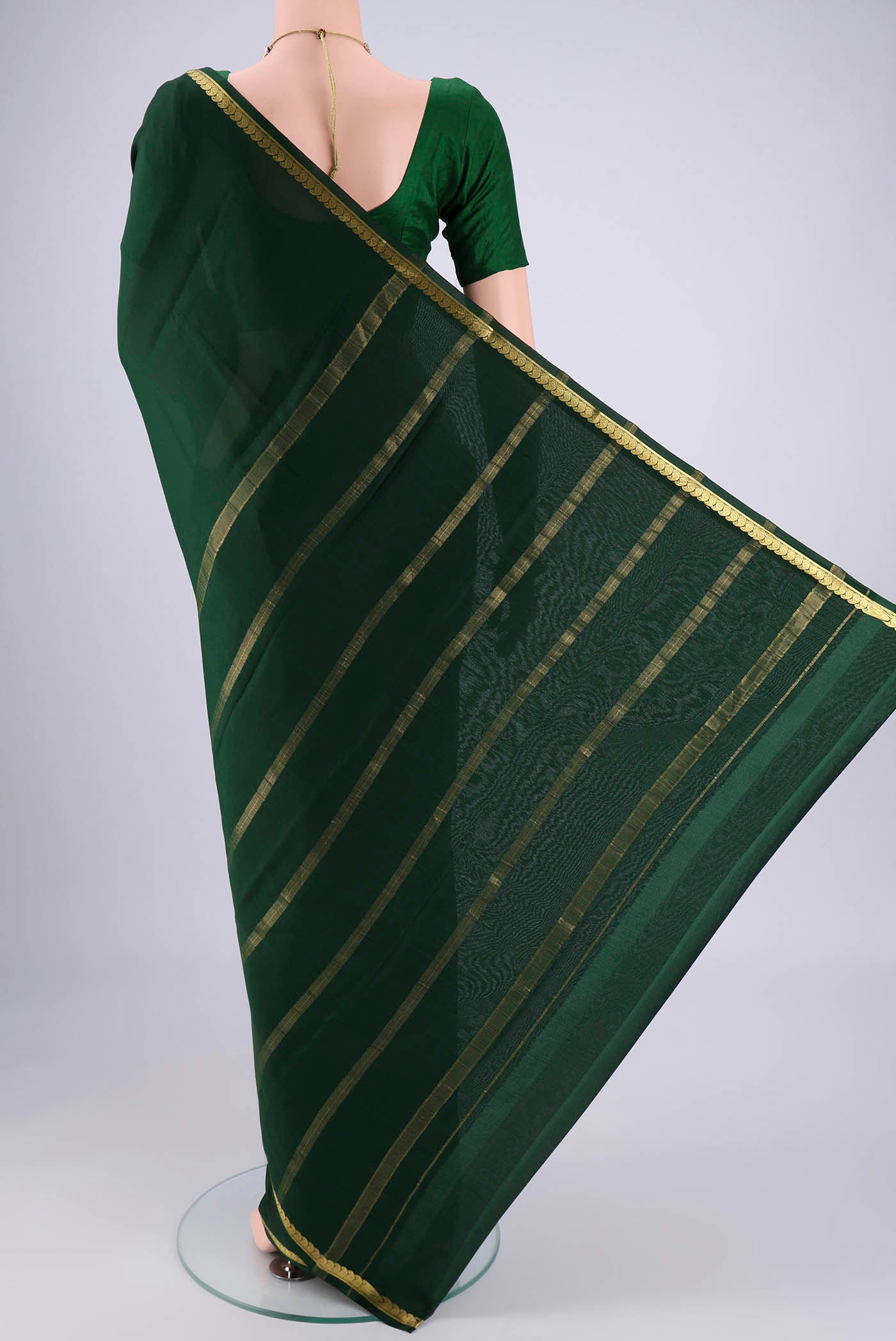 Flat view of Bottle Green Mysore Crepe Saree with Plain Body and Zari Border. 