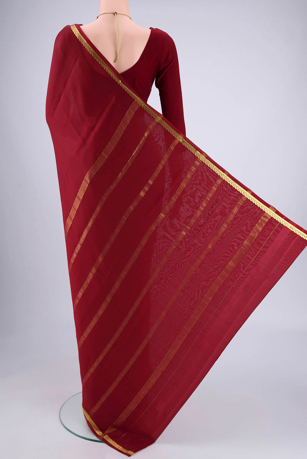 Flat view of Maroon Mysore Crepe Saree with Plain Body and Zari Border. 