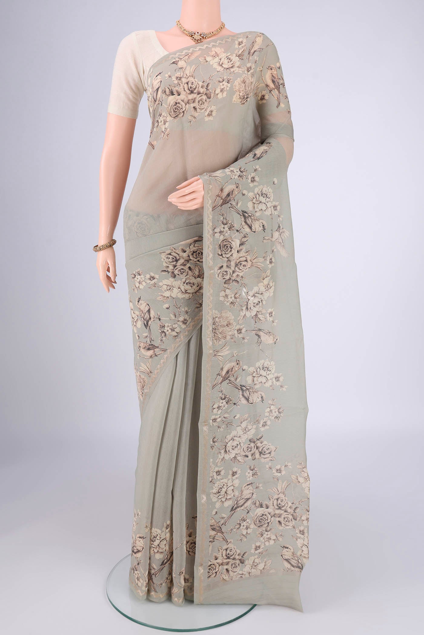 Davys Grey Chanderi Silk Cotton Saree with Floral Print on the body and Zari Border.  displayed on a mannequin