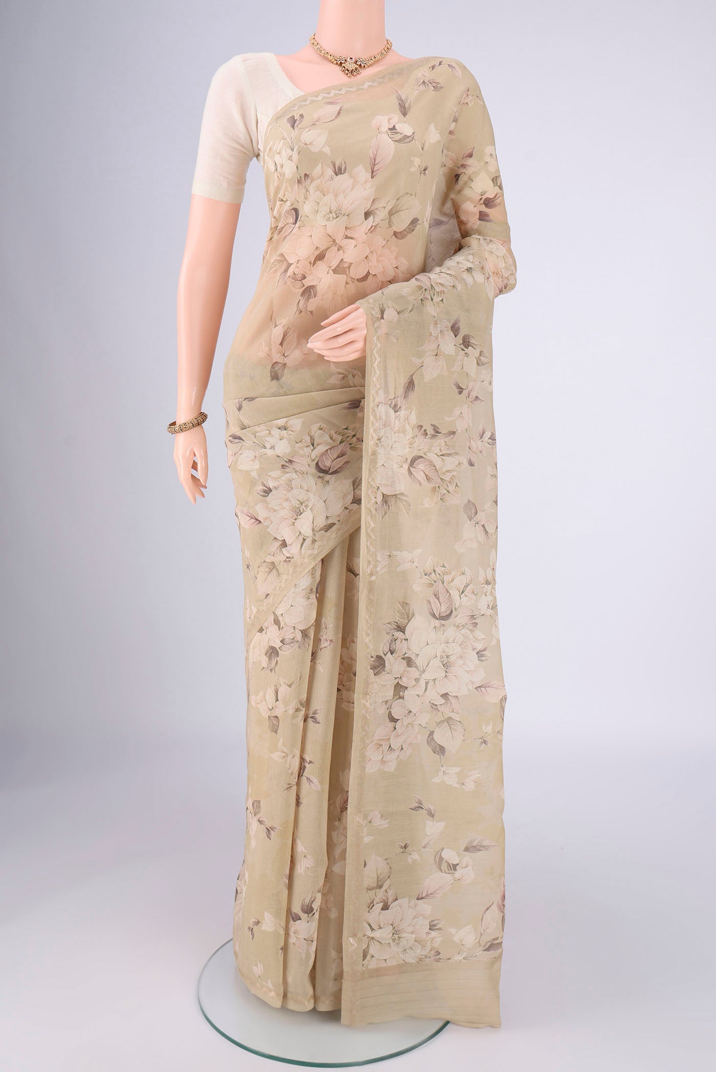Dark Beige Chanderi Silk Cotton Saree with Floral Print on the body and Zari Border.  displayed on a mannequin
