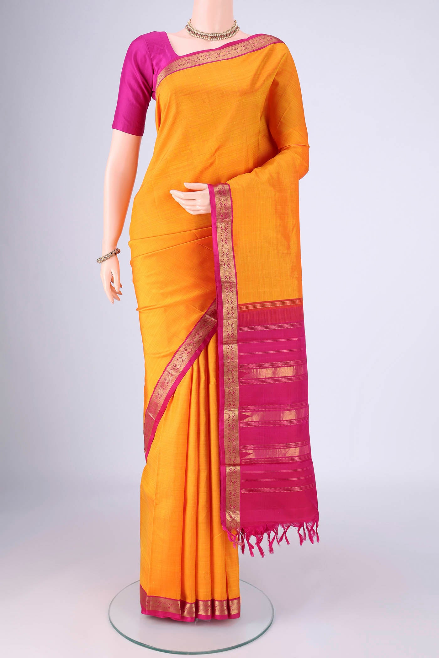 Pure Silk Pure Zari Yellow Kanjivaram Saree with Plain Body and Zari Border.  displayed on a mannequin