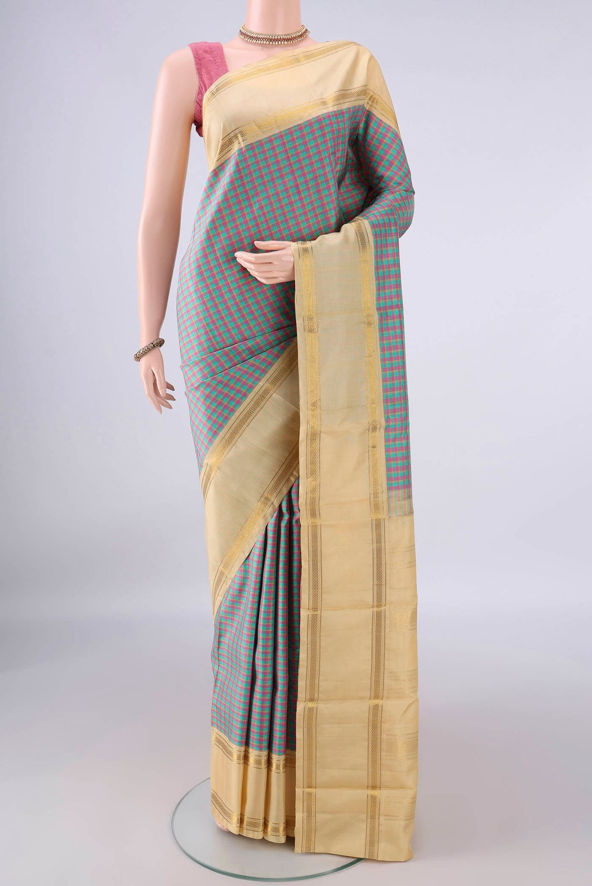Pure Silk Multi Color Kanjivaram Saree with Checked design on the body and Zari Border.  displayed on a mannequin