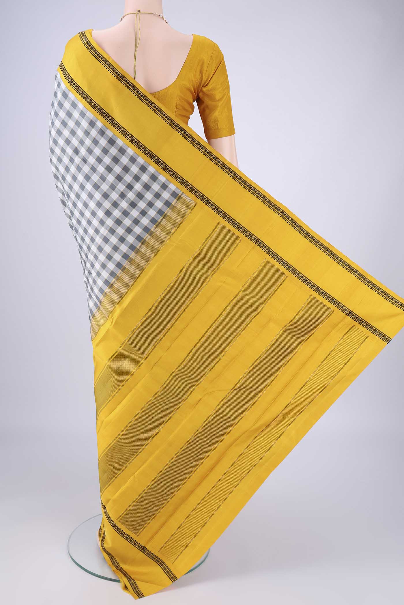 Flat view of Off White Kanjivaram Silk Saree with Checked design on the body and Thread Border. 