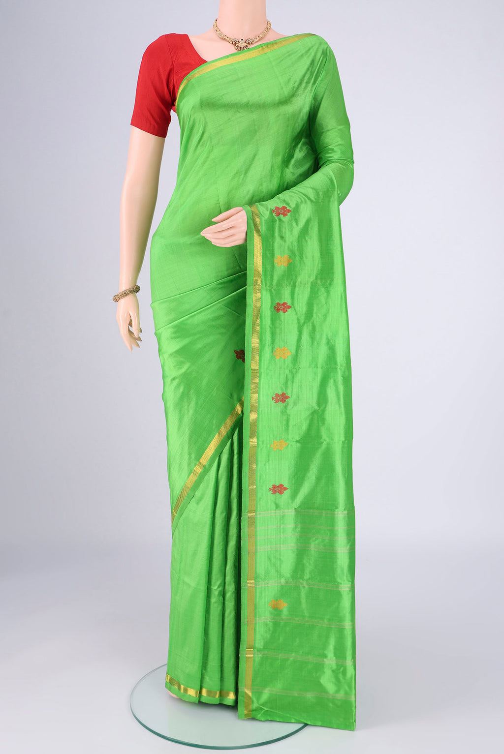 Parrot Green Dual Tone Kanchipuram Saree with Plain Body and Zari And Thread Border.  displayed on a mannequin