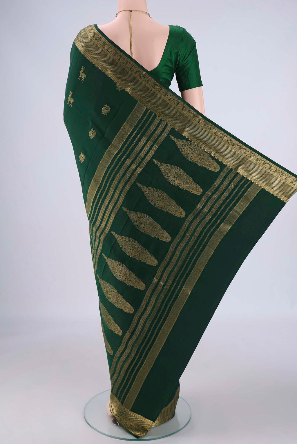 Flat view of Bottle Green Mysore Crepe Saree with Zari Butta on the body and Zari Border. 
