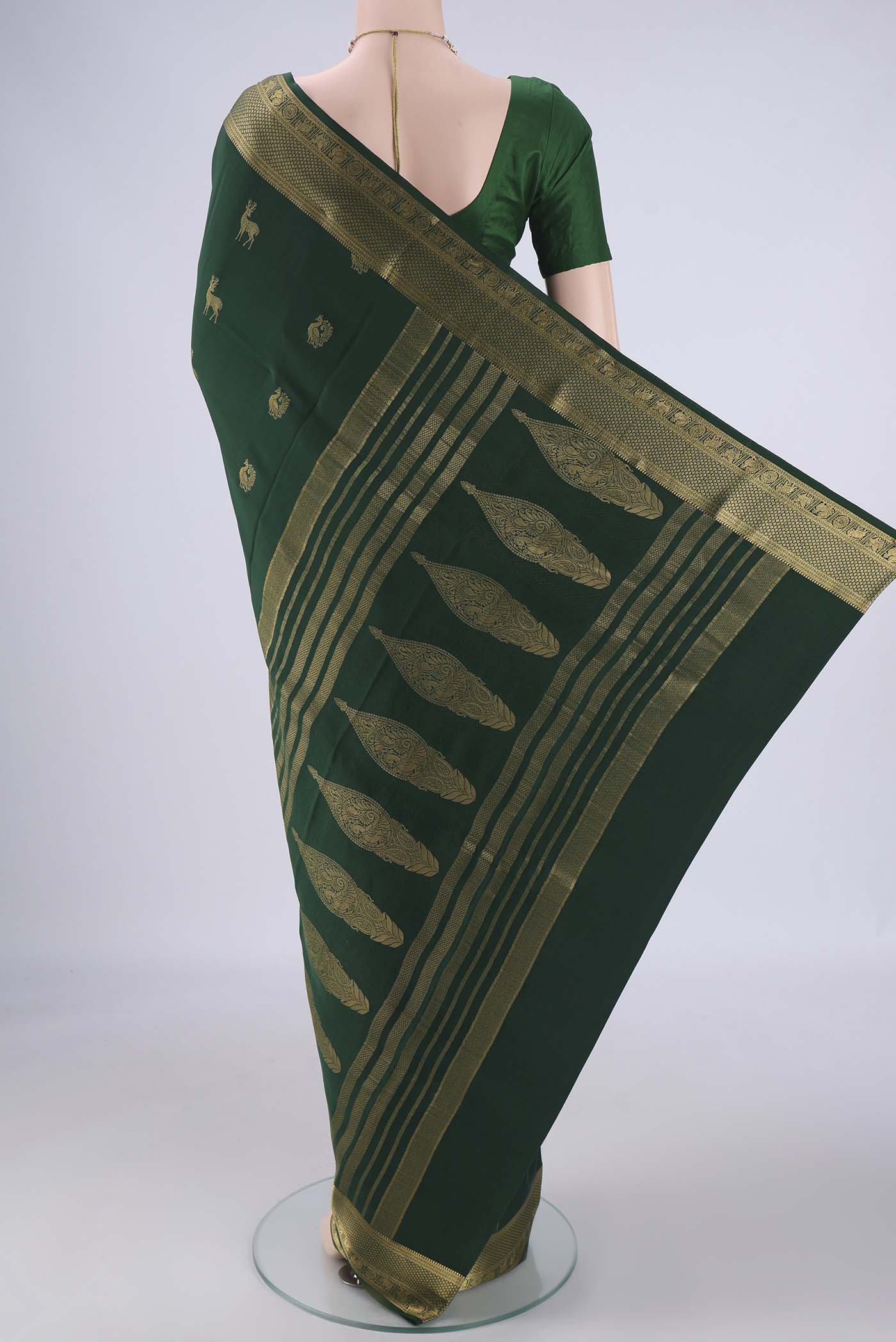 Flat view of Bottle Green Mysore Crepe Saree with Zari Butta on the body and Zari Border. 