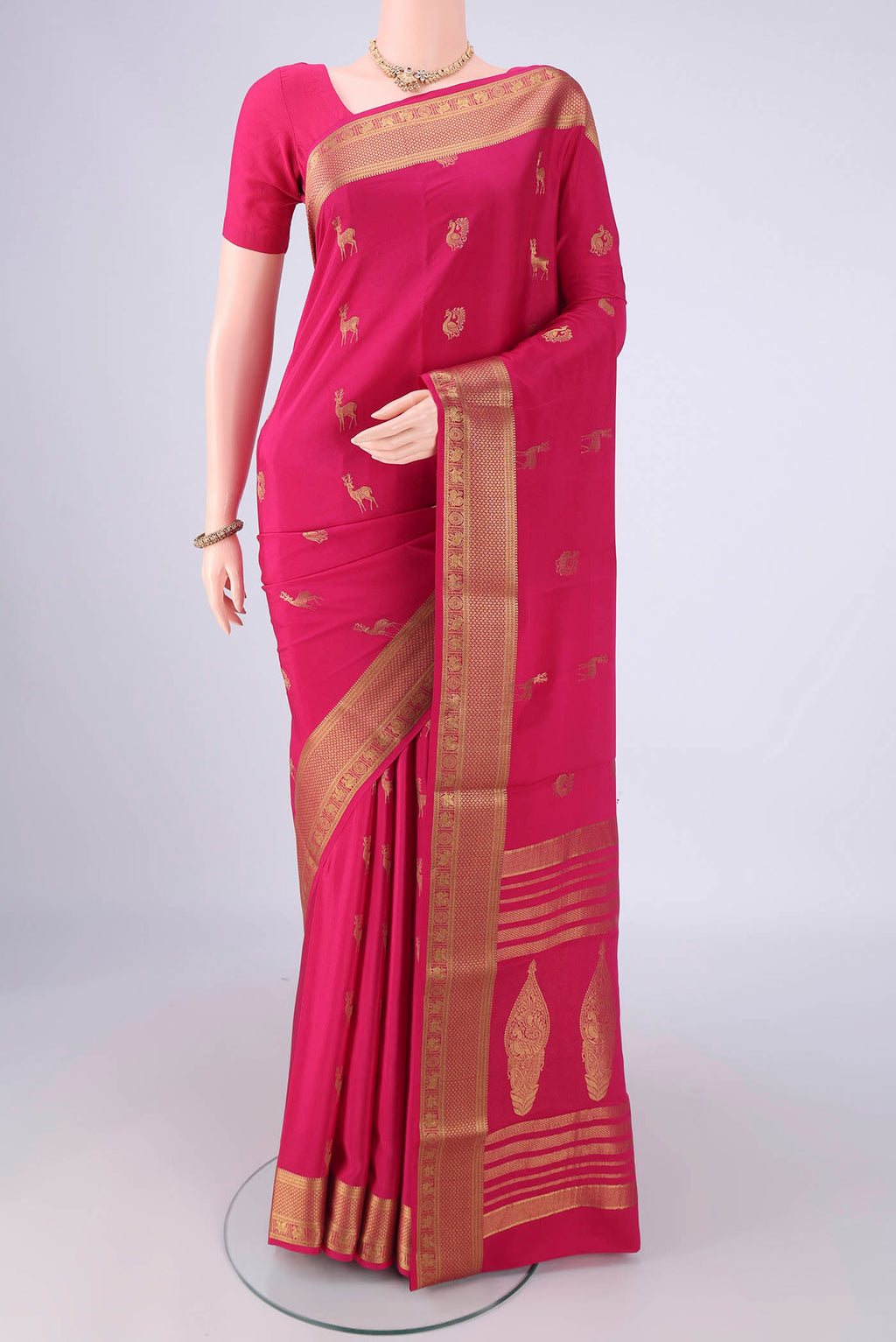 Rani Pink Mysore Crepe Saree with Zari Butta on the body and Zari Border.  displayed on a mannequin