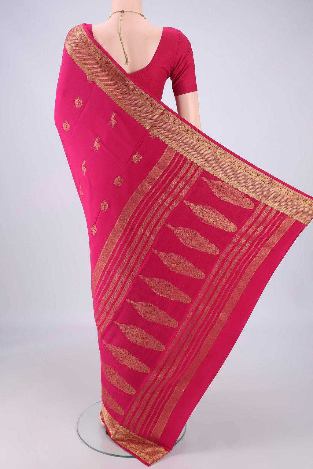 Flat view of Rani Pink Mysore Crepe Saree with Zari Butta on the body and Zari Border. 