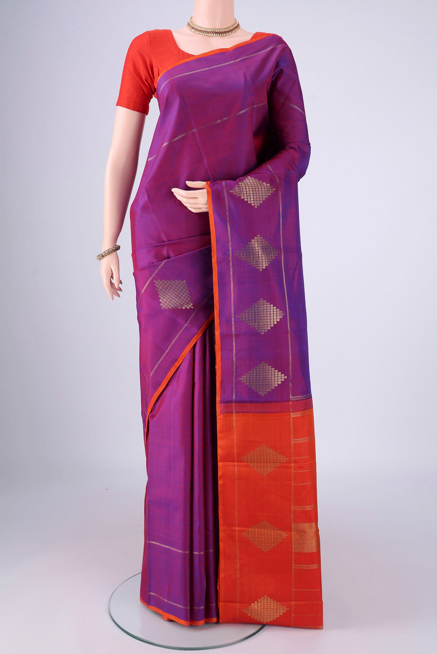 Purple Kanchipuram Silk Saree with Plain Body and Without Border.  displayed on a mannequin