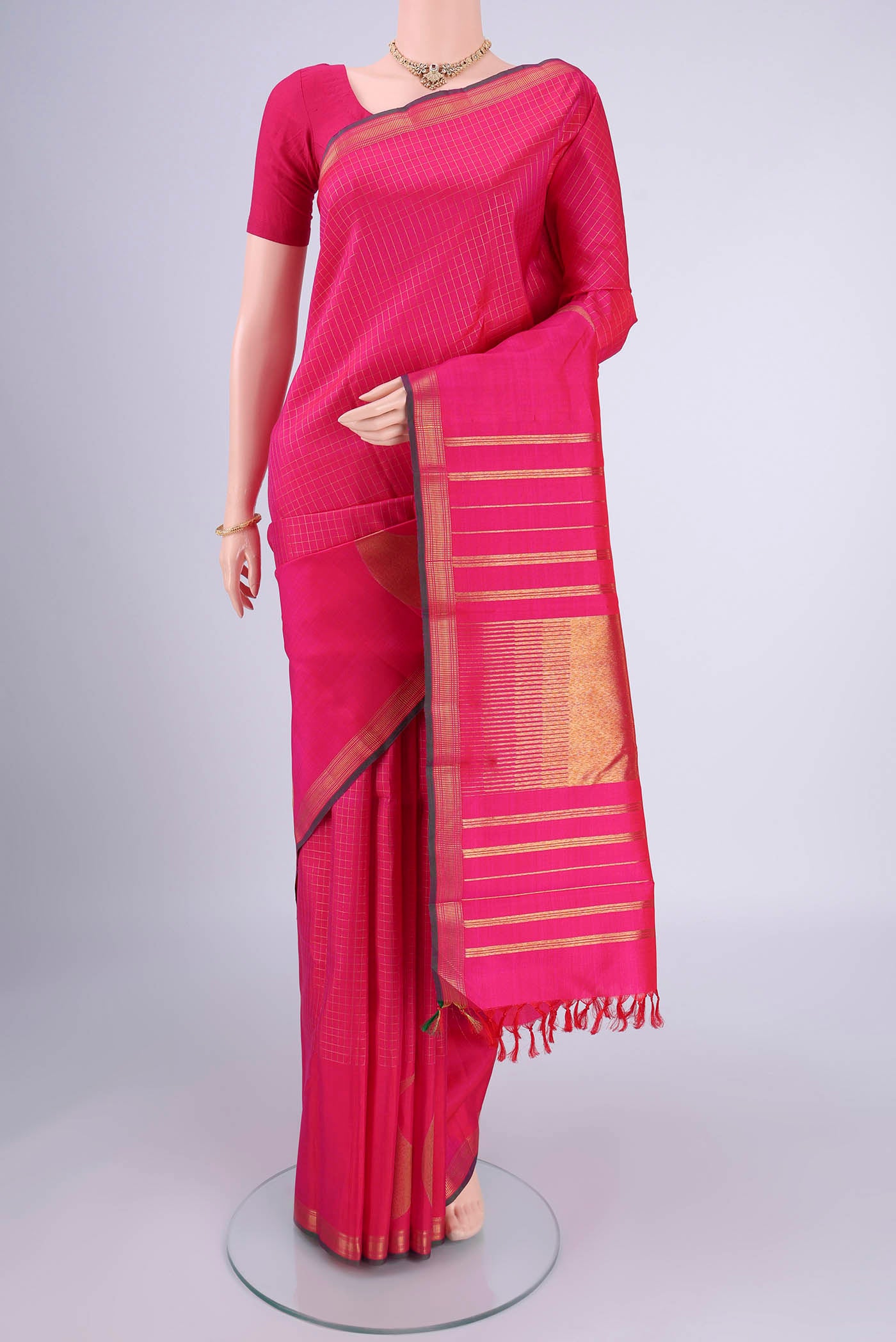 Pure Silk Pure Zari Rani Pink Kanchipuram Saree with Checked design on the body and Zari Border.  displayed on a mannequin