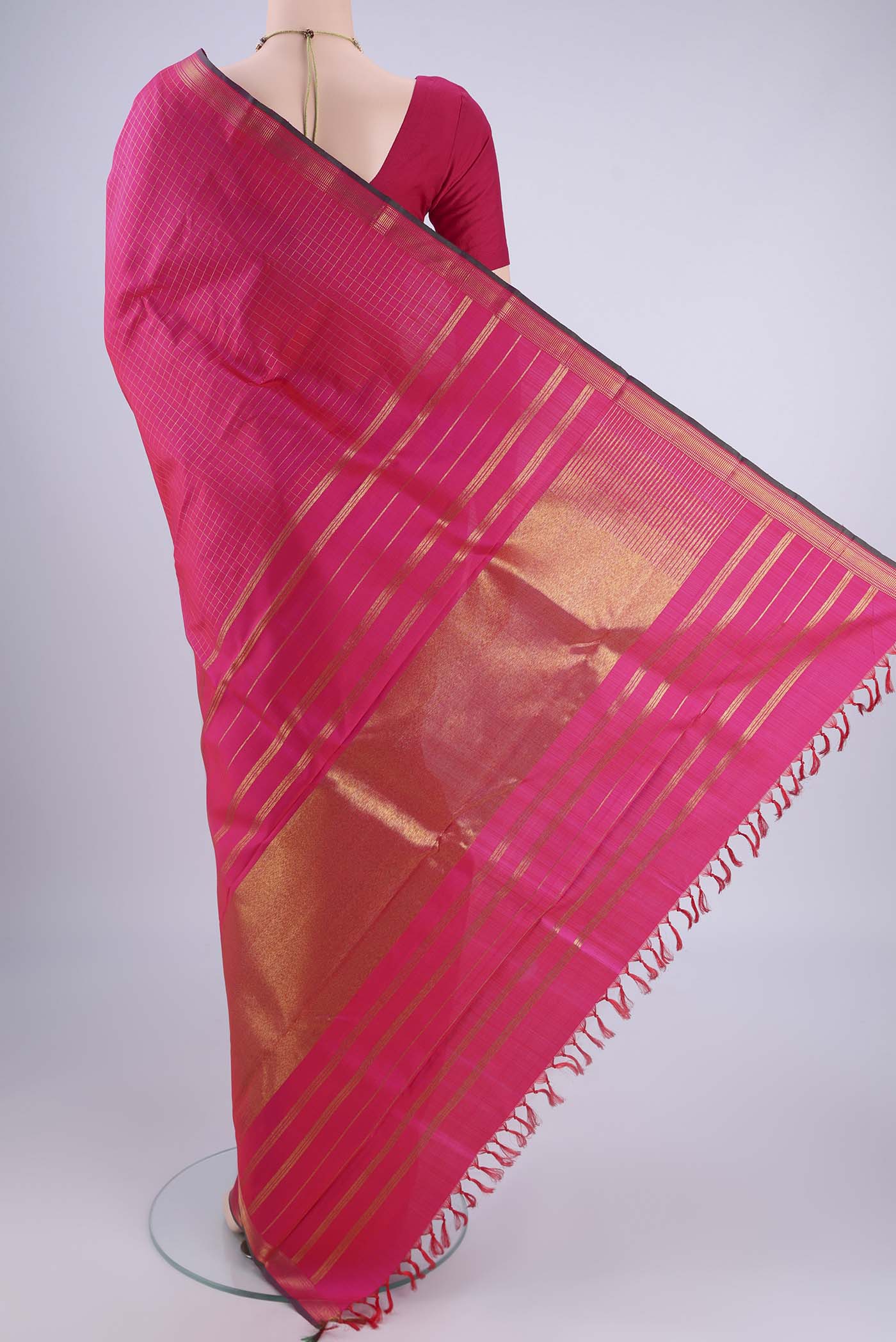 Flat view of Pure Silk Pure Zari Rani Pink Kanchipuram Saree with Checked design on the body and Zari Border. 