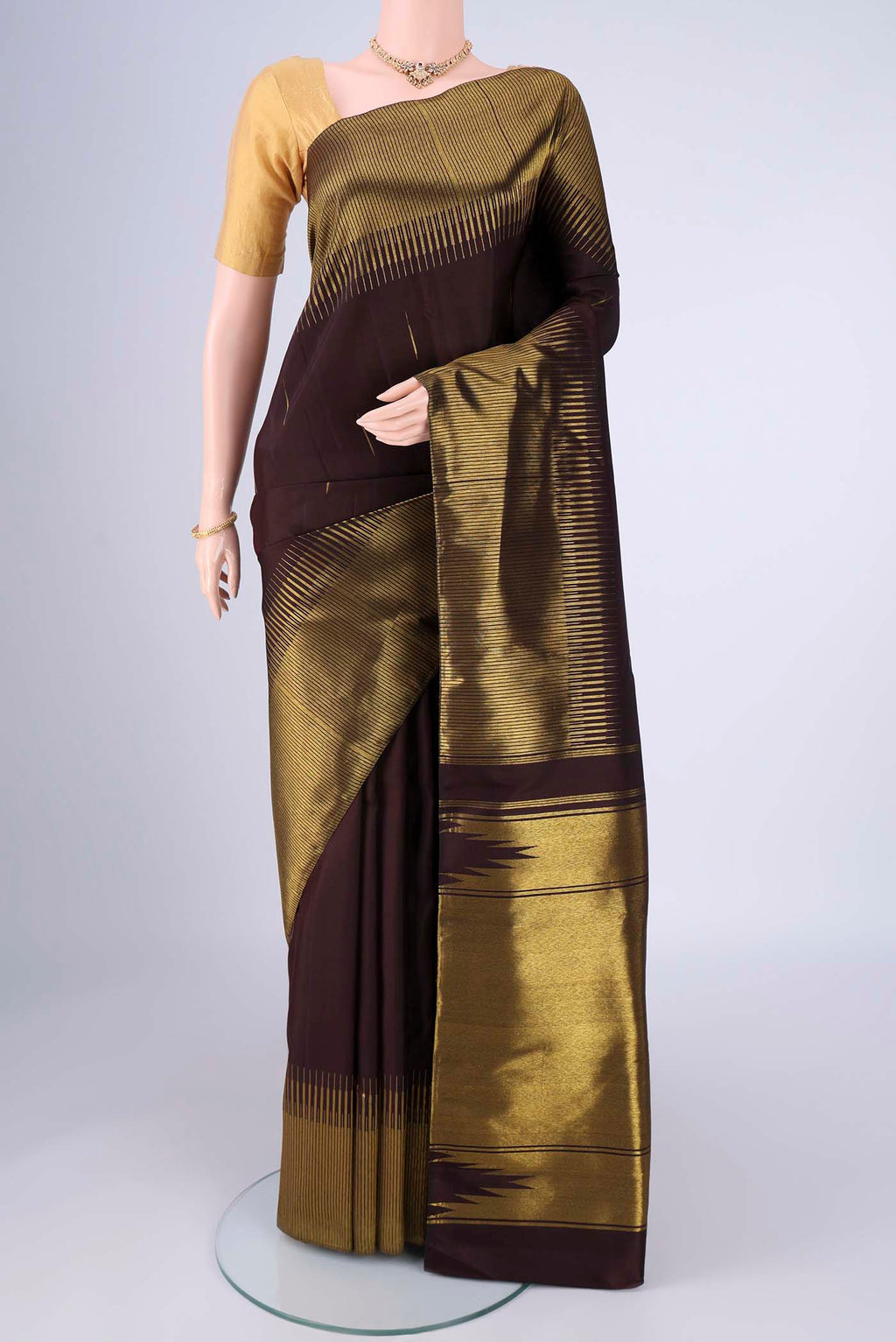 Coffee Brown Kanjivaram Silk Saree with Zari Butta on the body and Zari Border.  displayed on a mannequin
