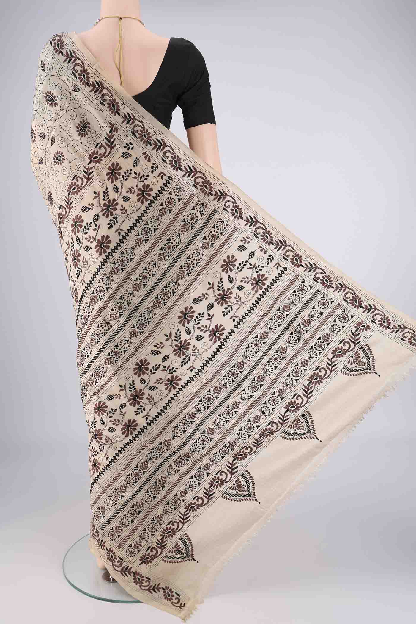 Flat view of Beige Tussar Silk Saree with Kantha Work on the body and Thread Border. 