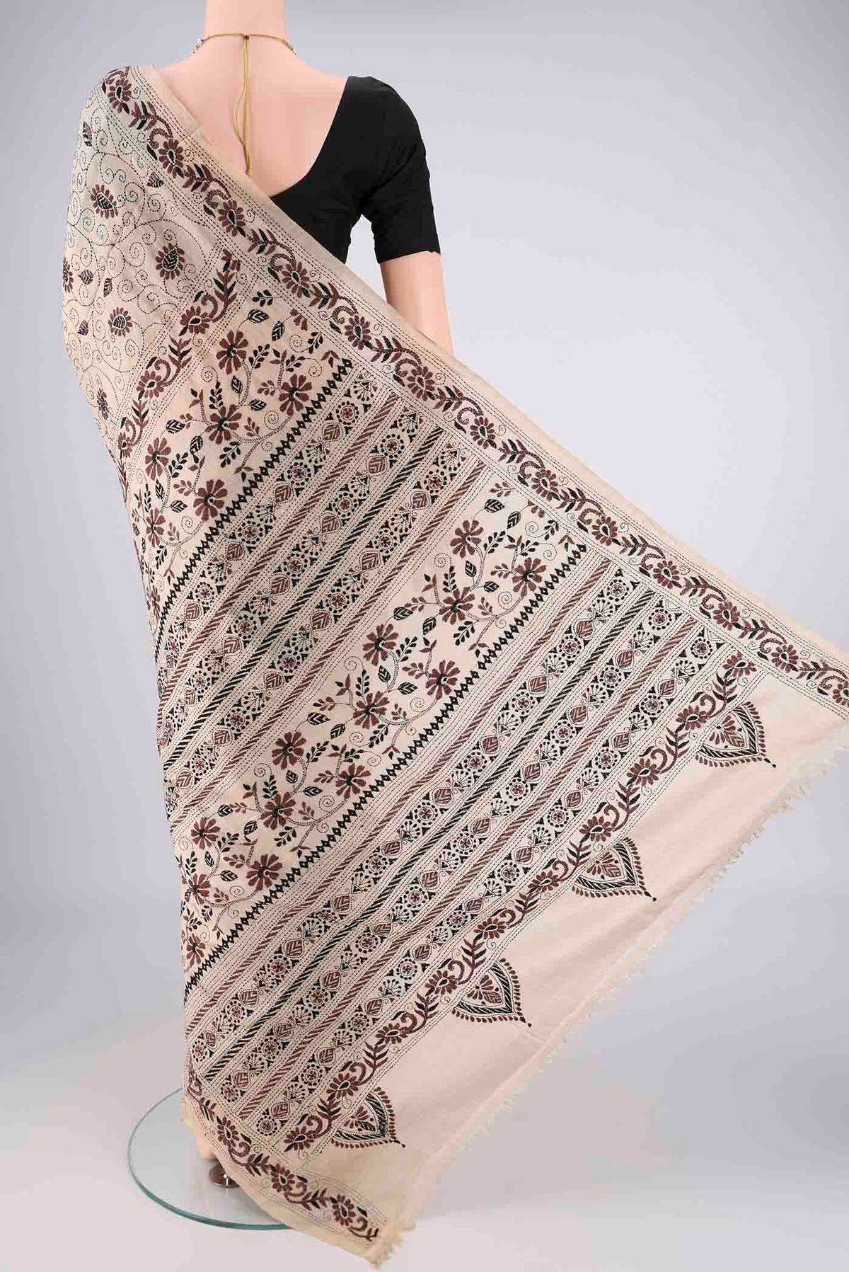 Flat view of Beige Tussar Silk Saree with Kantha Work on the body and Thread Border. 