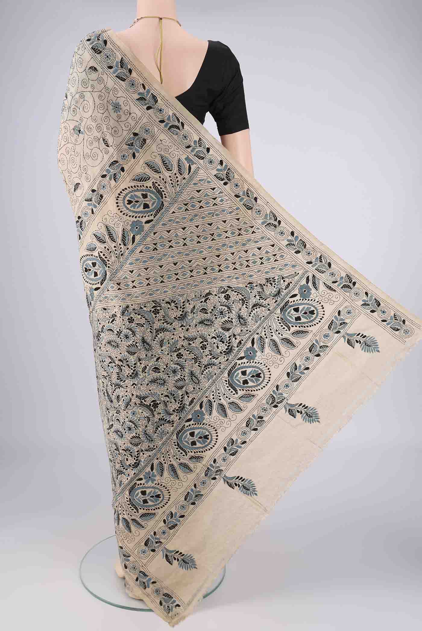 Flat view of Beige Tussar Silk Saree with Kantha Work on the body and Thread Border. 