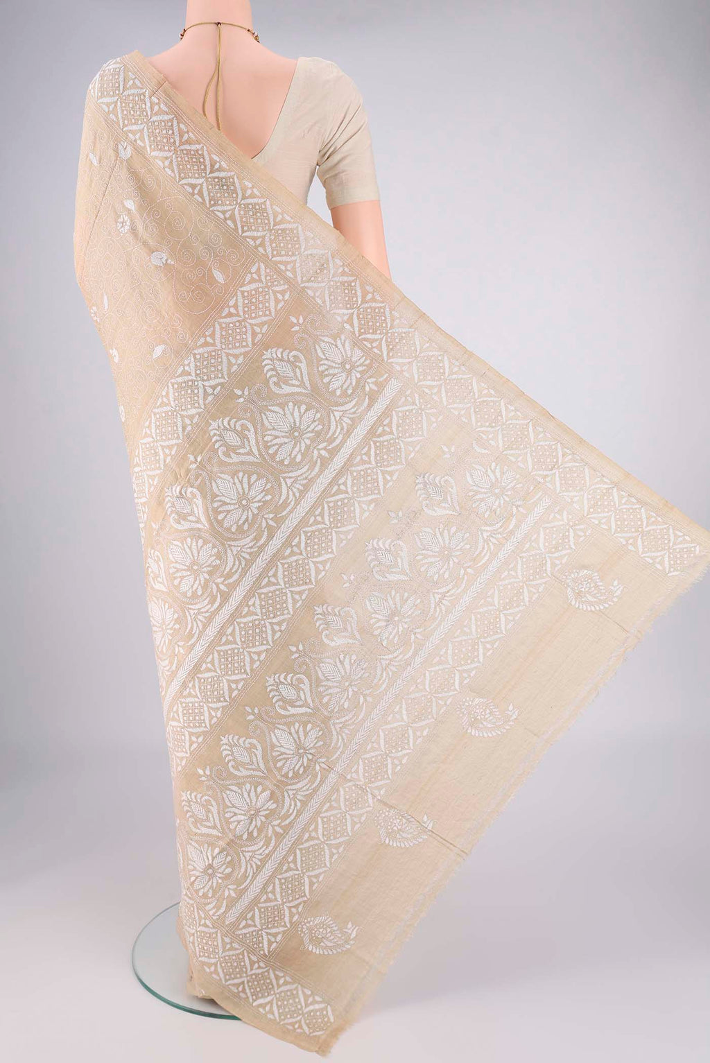 Flat view of Beige Tussar Silk Saree with Kantha Work on the body and Thread Border. 