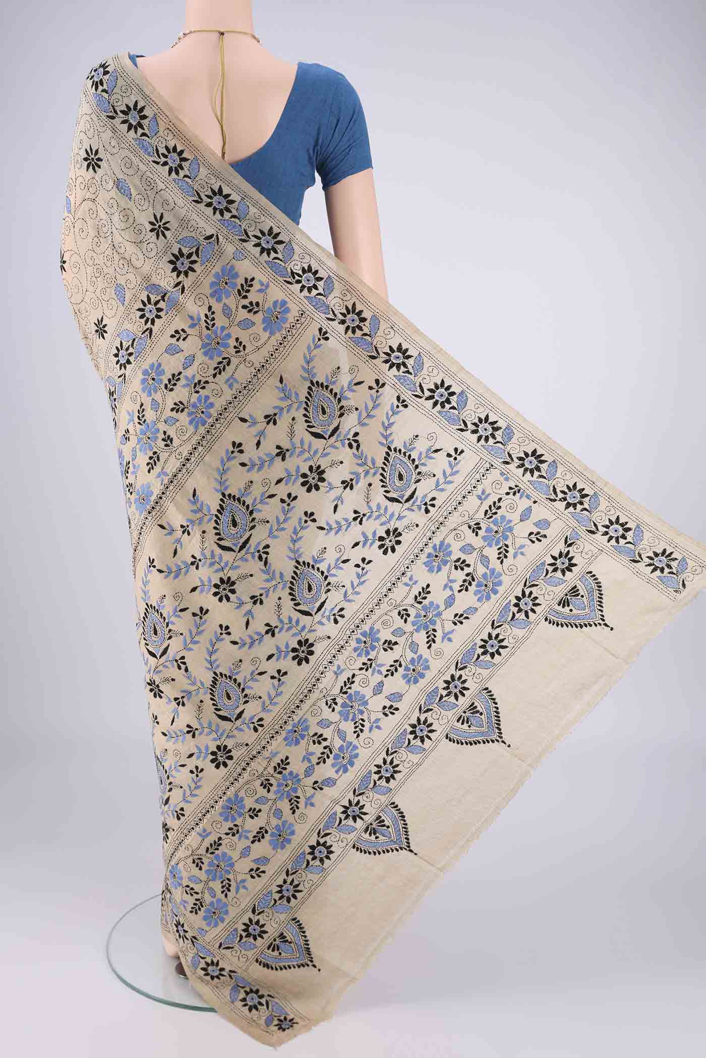 Flat view of Beige Tussar Silk Saree with Kantha Work on the body and Thread Border. 