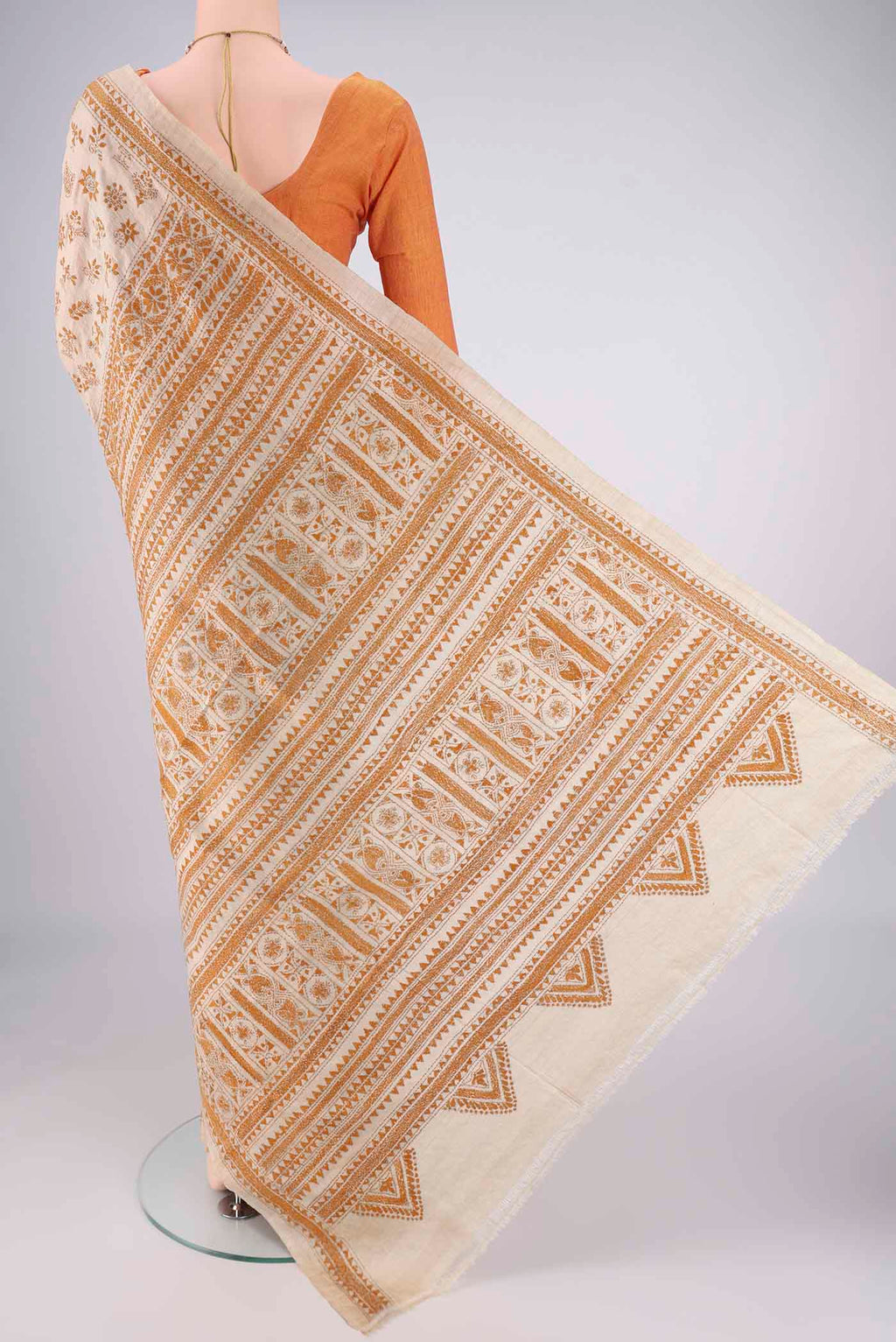 Flat view of Beige Tussar Silk Saree with Kantha Work on the body and Thread Border. 