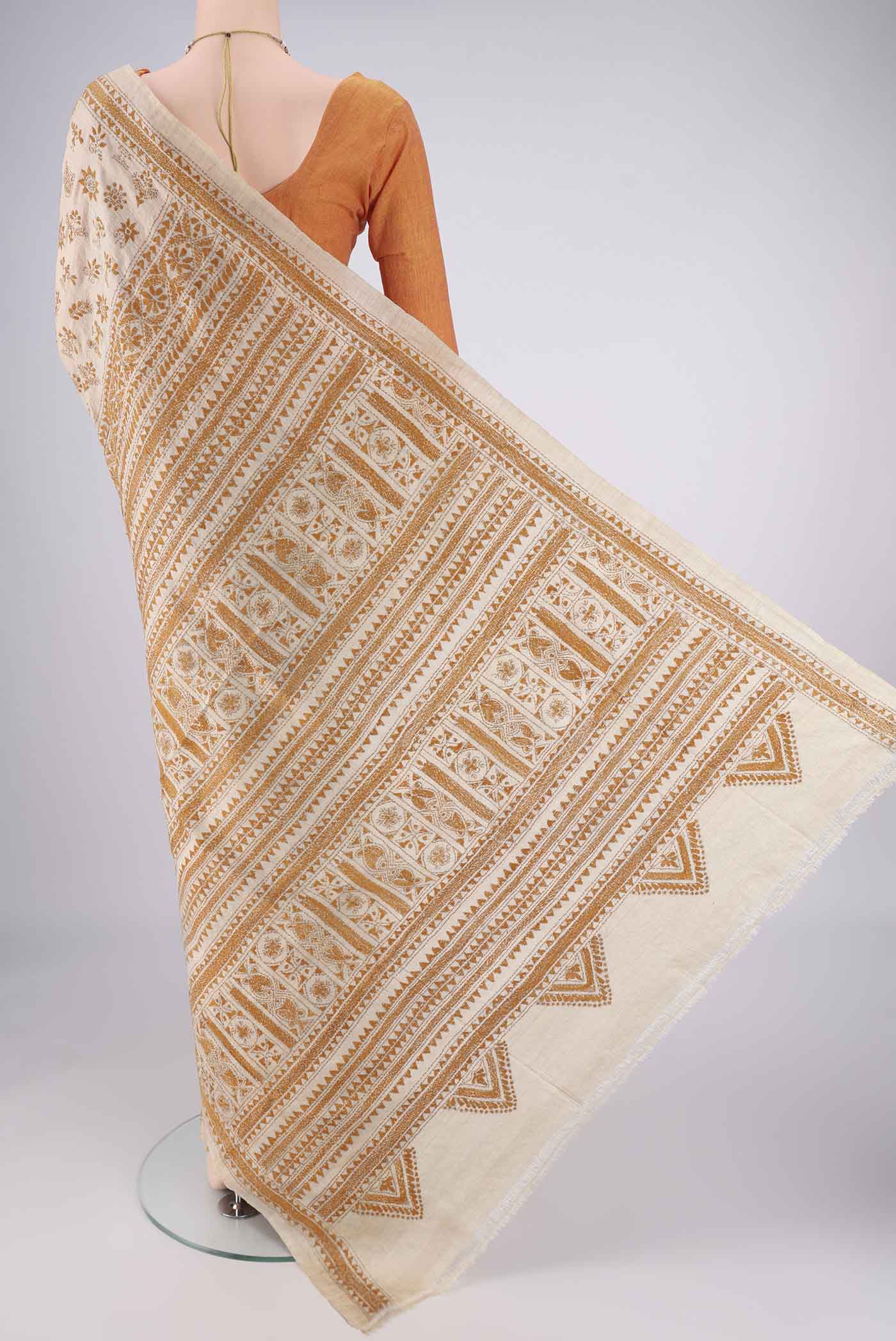 Flat view of Beige Tussar Silk Saree with Kantha Work on the body and Thread Border. 