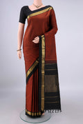 Pure Silk Rust Kanjivaram Saree with Plain Body and Zari Border.  displayed on a mannequin