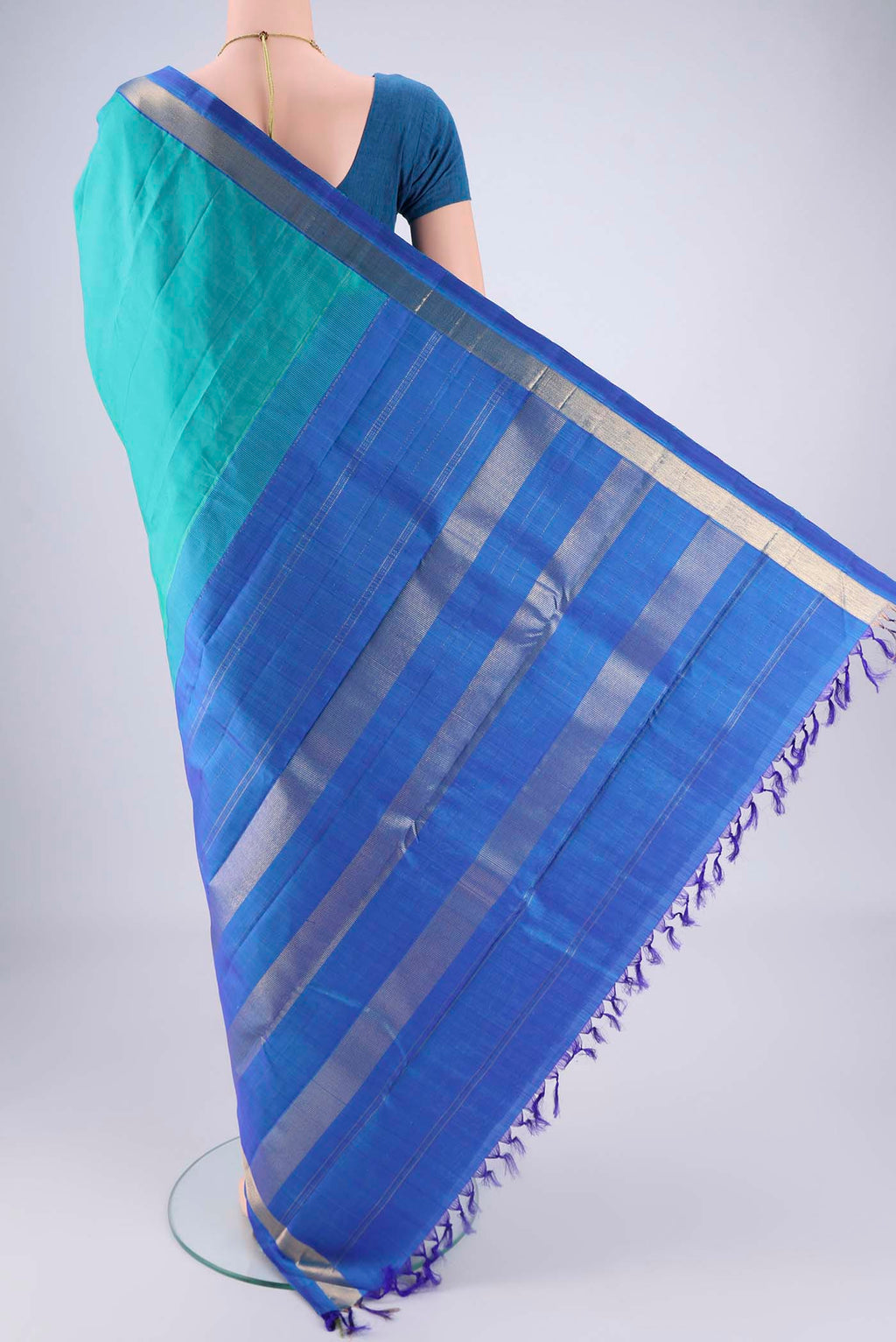 Flat view of Turquoise Kanjivaram Saree with Plain Body and Zari Border. 